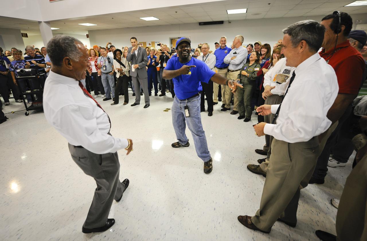 NASA Administrator Charles Bolden, left, and Robert Cabana, director Kennedy Space Center, react to employee Kenneth C. McElroy, early Thursday July 21, 2011, after Bolden and Cabana addressed employees prior to the landing of space shuttle Atlantis at NASA's Kennedy Space Center in Cape Canaveral, Fla. Photo Credit: (NASA/Bill Ingalls)