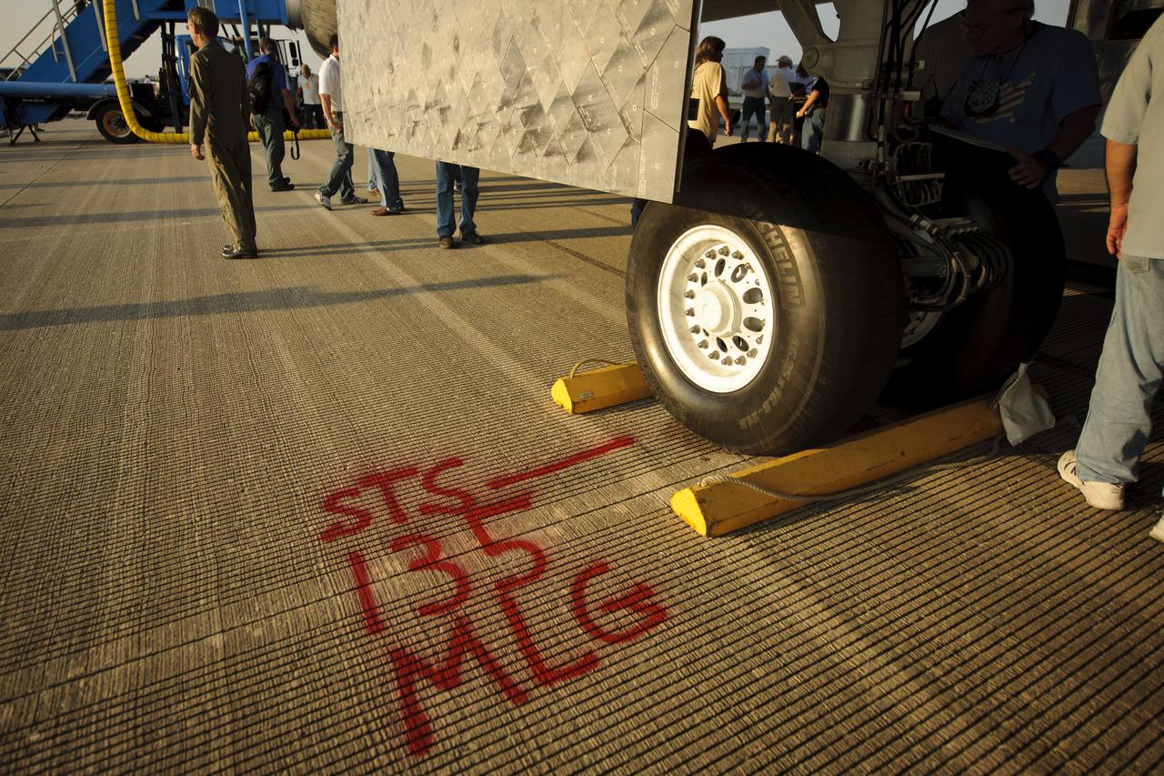 The runway of the Shuttle Landing Facility (SLF) is marked to show where the main landing gear wheels stopped for the space shuttle Atlantis (STS-135) shortly after it landed early Thursday morning, July 21, 2011, in Cape Canaveral, Fla. Overall, Atlantis spent 307 days in space and traveled nearly 126 million miles during its 33 flights. Atlantis, the fourth orbiter built, launched on its first mission on Oct. 3, 1985. Photo Credit: (NASA/Bill Ingalls)