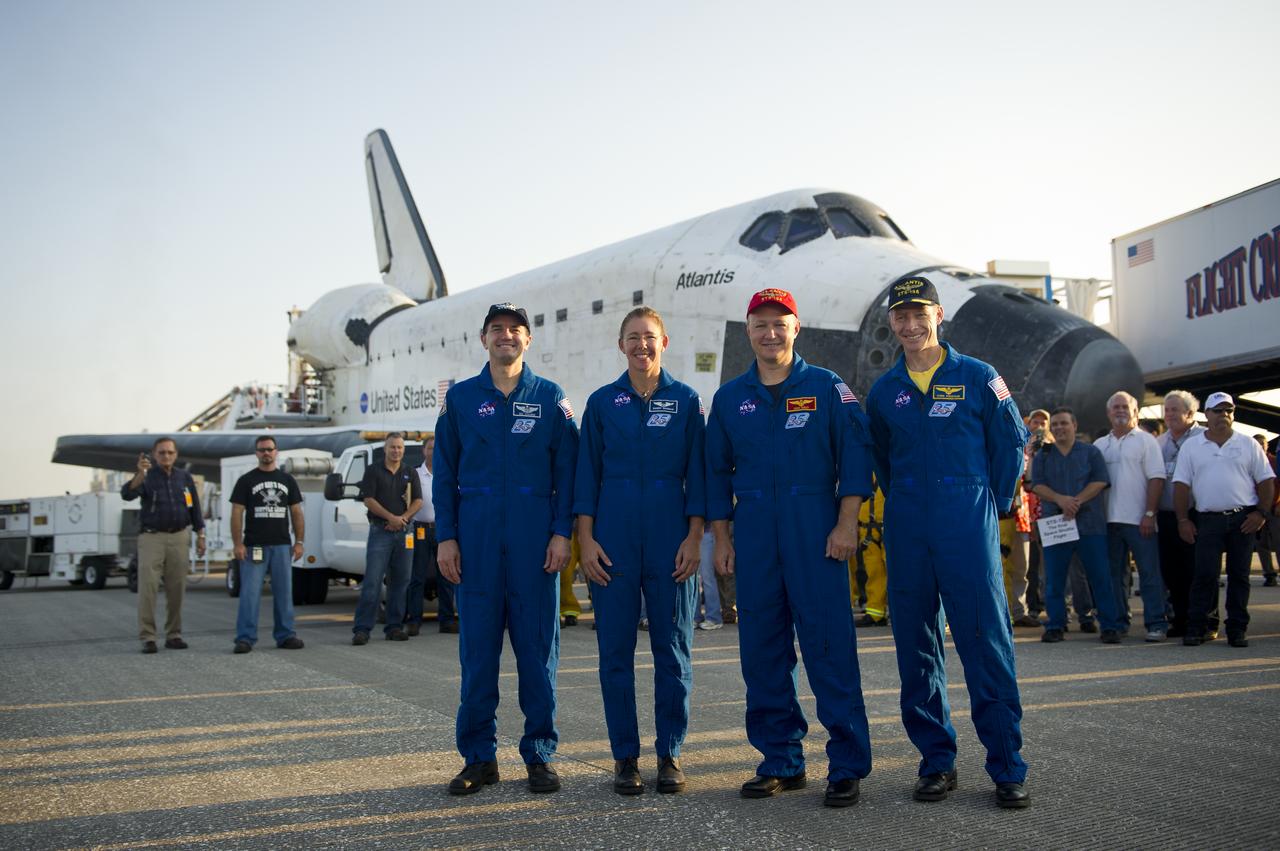 The STS-135 astronauts, from left, Mission Specialists Rex Walheim, Sandy Magnus, Pilot Doug Hurley and Commander Chris Ferguson all pose for photographers shortly after they touched down in the space shuttle Atlantis at NASA's Kennedy Space Center Shuttle Landing Facility (SLF), completing its 13-day mission to the International Space Station (ISS) and the final flight of the Space Shuttle Program, early Thursday morning, July 21, 2011, in Cape Canaveral, Fla. Overall, Atlantis spent 307 days in space and traveled nearly 126 million miles during its 33 flights. Atlantis, the fourth orbiter built, launched on its first mission on Oct. 3, 1985. Photo Credit: (NASA/Bill Ingalls)