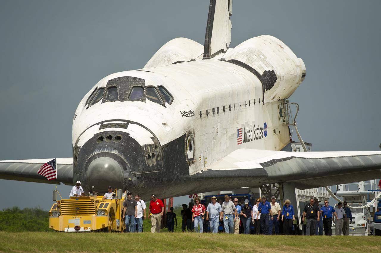 Space shuttle Atlantis (STS-135) is rolled over to the Orbiter Processing Facility (OPF) shortly after landing at NASA's Kennedy Space Center Shuttle Landing Facility (SLF), completing its 13-day mission to the International Space Station (ISS) and the final flight of the Space Shuttle Program, early Thursday morning, July 21, 2011, in Cape Canaveral, Fla. Overall, Atlantis spent 307 days in space and traveled nearly 126 million miles during its 33 flights. Atlantis, the fourth orbiter built, launched on its first mission on Oct. 3, 1985. Photo Credit: (NASA/Bill Ingalls)