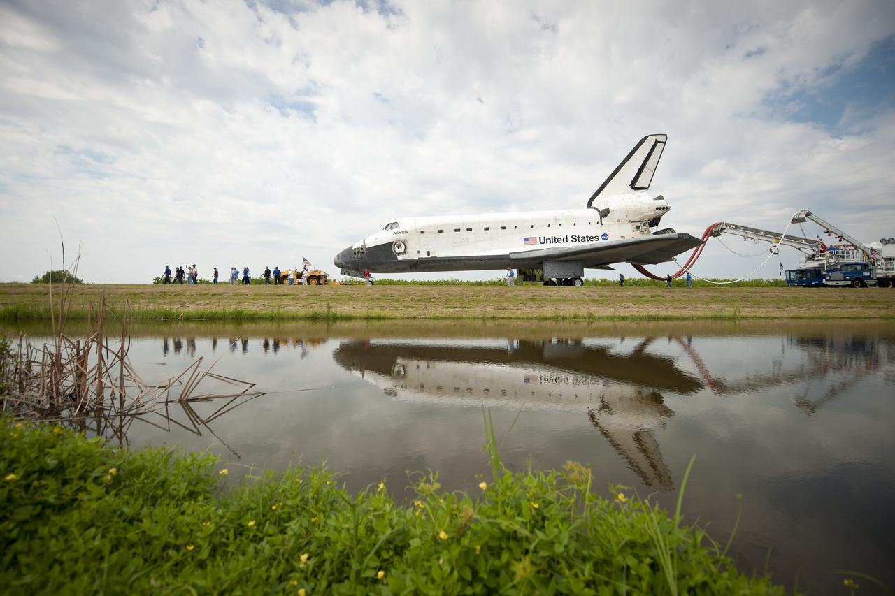 Space shuttle Atlantis (STS-135) is rolled over to the Orbiter Processing Facility (OPF) shortly after landing at NASA's Kennedy Space Center Shuttle Landing Facility (SLF), completing its 13-day mission to the International Space Station (ISS) and the final flight of the Space Shuttle Program, early Thursday morning, July 21, 2011, in Cape Canaveral, Fla. Overall, Atlantis spent 307 days in space and traveled nearly 126 million miles during its 33 flights. Atlantis, the fourth orbiter built, launched on its first mission on Oct. 3, 1985. Photo Credit: (NASA/Bill Ingalls)