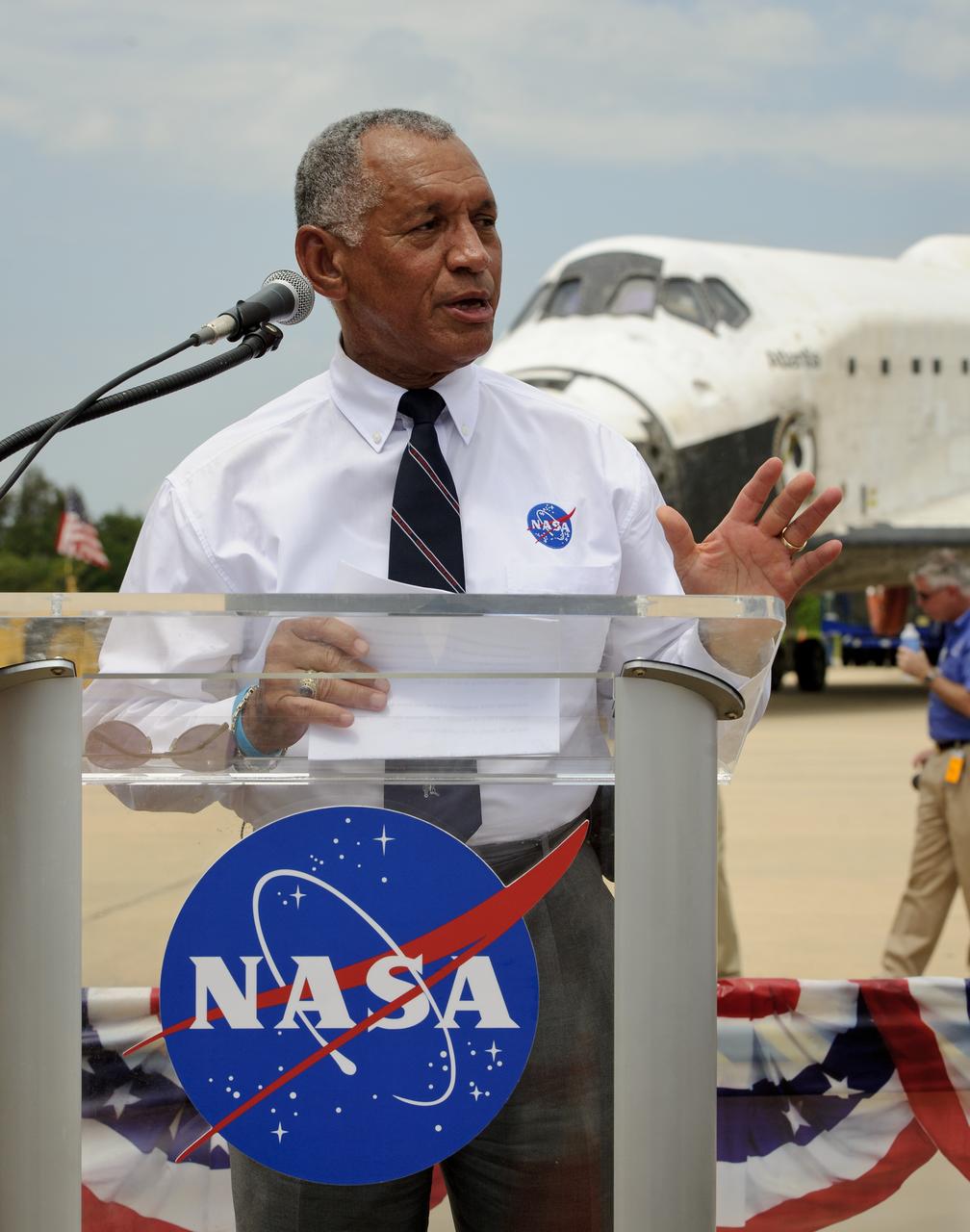 NASA administrator Charles Bolden addresses Kennedy Space Center employees and contractors as space shuttle Atlantis (STS-135) sits in the background near the Orbiter Processing Facility (OPF) at a wheels stop event, Thursday, July 21, 2011, in Cape Canaveral, Fla. Atlantis returned to Kennedy early Thursday following a 13-day mission to the International Space Station (ISS) and marking the end of the 30-year Space Shuttle Program. Overall, Atlantis spent 307 days in space and traveled nearly 126 million miles during its 33 flights. Atlantis, the fourth orbiter built, launched on its first mission on Oct. 3, 1985. Photo Credit: (NASA/Paul E. Alers)