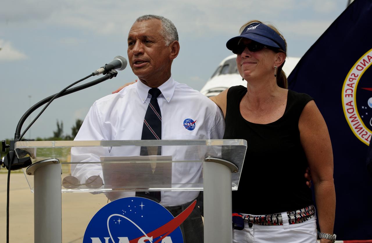 NASA administrator Charles Bolden along with Deputy Administrator Lori Garver addresses Kennedy Space Center employees and contractors as space shuttle Atlantis (STS-135) sits in the background near the Orbiter Processing Facility (OPF) at a wheels stop event, Thursday, July 21, 2011, in Cape Canaveral, Fla. Atlantis returned to Kennedy early Thursday following a 13-day mission to the International Space Station (ISS) and marking the end of the 30-year Space Shuttle Program. Overall, Atlantis spent 307 days in space and traveled nearly 126 million miles during its 33 flights. Atlantis, the fourth orbiter built, launched on its first mission on Oct. 3, 1985. Photo Credit: (NASA/Paul E. Alers)