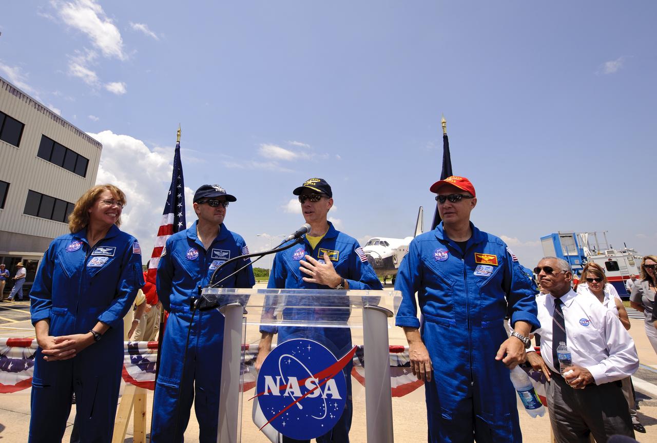 Space shuttle Atlantis (STS-135) Commander Chris Furgeson, at podium, is flanked by his crew pilot Doug Hurley, right, and mission specialists Rex Walheim  and Sandy Mangus, left, as he addresses employees and contractors gathered at a wheels stop event at NASA's Kennedy Space Center, Thursday, July 21, 2011, in Cape Cape Canaveral, Fla. Atlantis returned to Kennedy early Thursday following a 13-day mission to the International Space Station (ISS) and marking the end of the 30-year Space Shuttle Program. Overall, Atlantis spent 307 days in space and traveled nearly 126 million miles during its 33 flights. Atlantis, the fourth orbiter built, launched on its first mission on Oct. 3, 1985. Photo Credit: (NASA/Paul E. Alers)