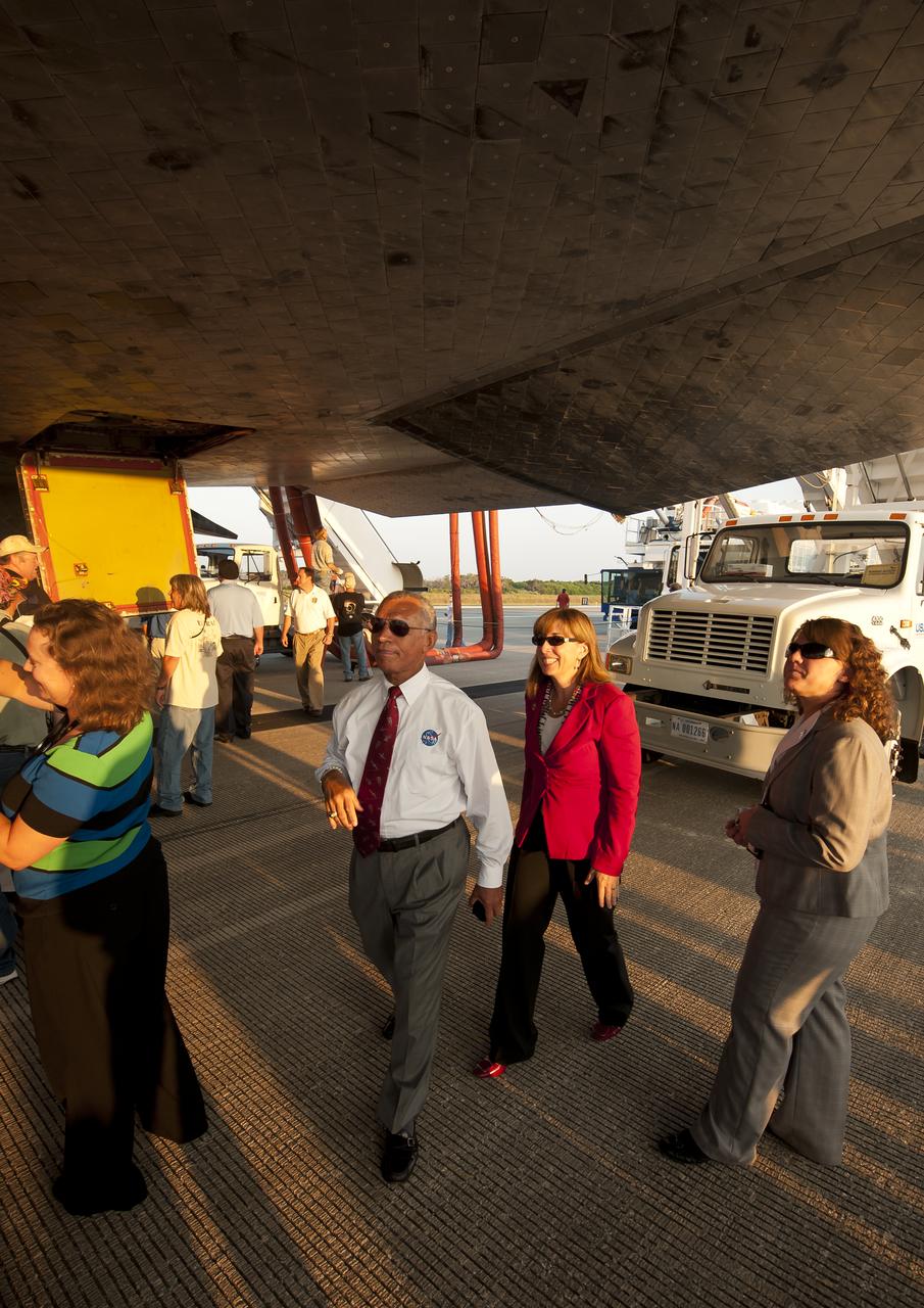 NASA Administrator Charles Bolden and Deputy Administrator Lori Garver walk under the space shuttle Atlantis at the Kennedy Space Center Shuttle Landing Facility (SLF) shortly after Atlantis (STS-135) landed early Thursday morning, July 21, 2011, in Cape Canaveral, Fla. Overall, Atlantis spent 307 days in space and traveled nearly 126 million miles during its 33 flights. Atlantis, the fourth orbiter built, launched on its first mission on Oct. 3, 1985. Photo Credit: (NASA/Bill Ingalls)
