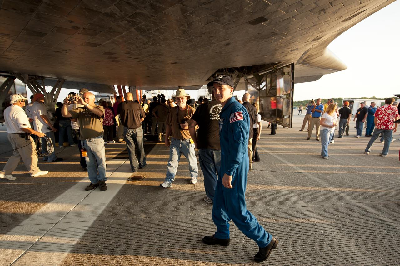 STS-135 Mission Specialist Rex Walheim walks under the space shuttle Atlantis shortly after he and the rest of the STS-135 crew landed at NASA's Kennedy Space Center Shuttle Landing Facility (SLF), completing a 13-day mission to the International Space Station (ISS) and the final flight of the Space Shuttle Program, early Thursday morning, July 21, 2011, in Cape Canaveral, Fla. Overall, Atlantis spent 307 days in space and traveled nearly 126 million miles during its 33 flights. Atlantis, the fourth orbiter built, launched on its first mission on Oct. 3, 1985. Photo Credit: (NASA/Bill Ingalls)