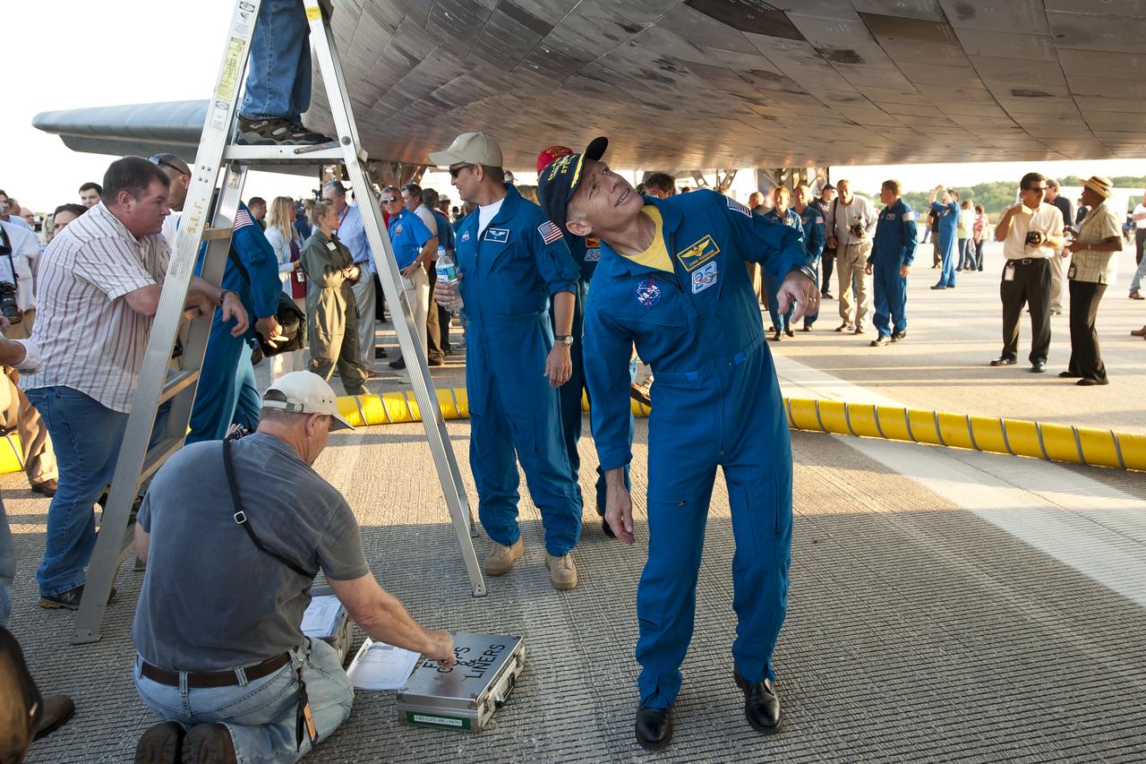 NASA Astronaut and STS-135 Commander Chris Ferguson walks underneath the space shuttle Atlantis shortly after he and the rest of the STS-135 crew landed at NASA's Kennedy Space Center Shuttle Landing Facility (SLF), completing a 13-day mission to the International Space Station (ISS) and the final flight of the Space Shuttle Program, early Thursday morning, July 21, 2011, in Cape Canaveral, Fla. Overall, Atlantis spent 307 days in space and traveled nearly 126 million miles during its 33 flights. Atlantis, the fourth orbiter built, launched on its first mission on Oct. 3, 1985. Photo Credit: (NASA/Bill Ingalls)