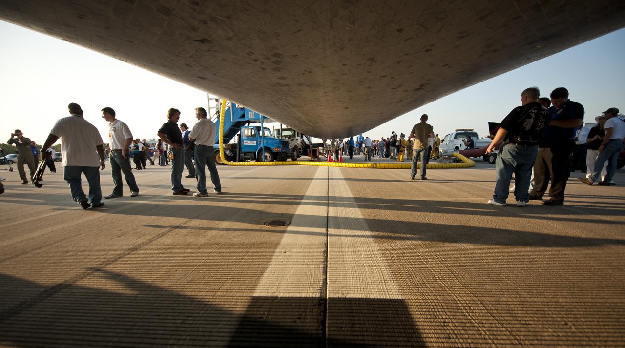 A view looking forward underneath the space shuttle Atlantis on the Shuttle Landing Facility (SLF) runway at NASA Kennedy Space Center shortly after it landed with the STS-135 crew, completing its 13-day mission to the International Space Station (ISS) and the final flight of the Space Shuttle Program, early Thursday morning, July 21, 2011, in Cape Canaveral, Fla. Overall, Atlantis spent 307 days in space and traveled nearly 126 million miles during its 33 flights. Atlantis, the fourth orbiter built, launched on its first mission on Oct. 3, 1985. Photo Credit: (NASA/Bill Ingalls)