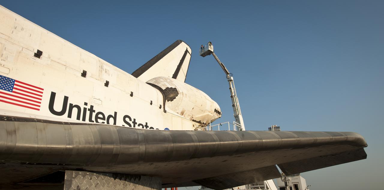 NASA and contractor personnel work on the space shuttle Atlantis at the Kennedy Space Center Shuttle Landing Facility (SLF) shortly after Atlantis (STS-135) landed early Thursday morning, July 21, 2011, in Cape Canaveral, Fla. Overall, Atlantis spent 307 days in space and traveled nearly 126 million miles during its 33 flights. Atlantis, the fourth orbiter built, launched on its first mission on Oct. 3, 1985. Photo Credit: (NASA/Bill Ingalls)
