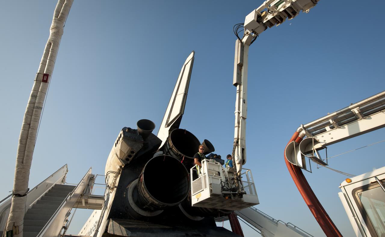 NASA and contractor personnel work on the space shuttle Atlantis at the Kennedy Space Center Shuttle Landing Facility (SLF) shortly after Atlantis (STS-135) landed early Thursday morning, July 21, 2011, in Cape Canaveral, Fla. Overall, Atlantis spent 307 days in space and traveled nearly 126 million miles during its 33 flights. Atlantis, the fourth orbiter built, launched on its first mission on Oct. 3, 1985. Photo Credit: (NASA/Bill Ingalls)