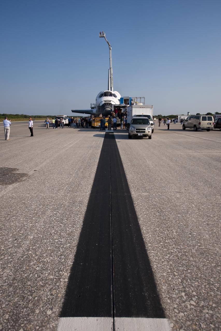 NASA and contractor personnel work on the space shuttle Atlantis at the Kennedy Space Center Shuttle Landing Facility (SLF) shortly after Atlantis (STS-135) landed early Thursday morning, July 21, 2011, in Cape Canaveral, Fla. Overall, Atlantis spent 307 days in space and traveled nearly 126 million miles during its 33 flights. Atlantis, the fourth orbiter built, launched on its first mission on Oct. 3, 1985. Photo Credit: (NASA/Bill Ingalls)