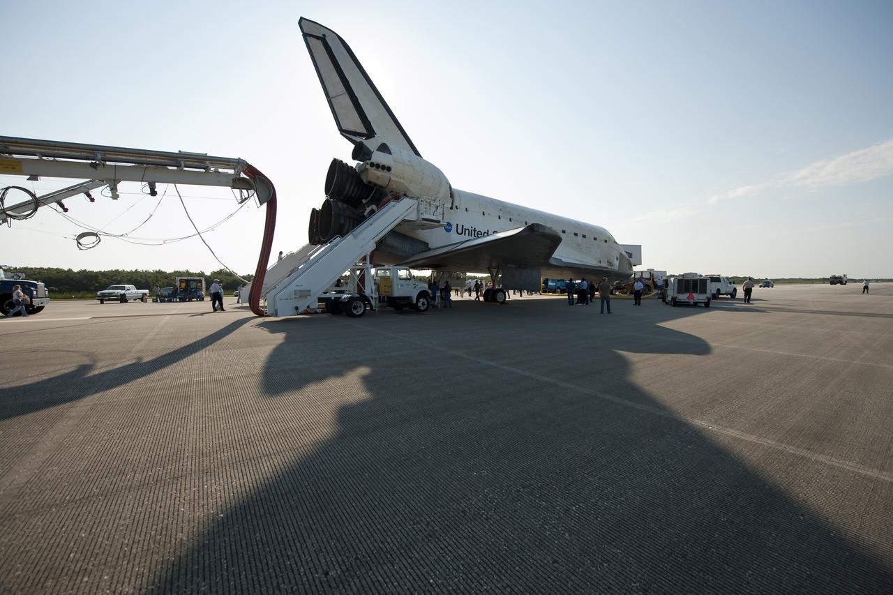 NASA and contractor personnel work on the space shuttle Atlantis at the Kennedy Space Center Shuttle Landing Facility (SLF) shortly after Atlantis (STS-135) landed early Thursday morning, July 21, 2011, in Cape Canaveral, Fla. Overall, Atlantis spent 307 days in space and traveled nearly 126 million miles during its 33 flights. Atlantis, the fourth orbiter built, launched on its first mission on Oct. 3, 1985. Photo Credit: (NASA/Bill Ingalls)