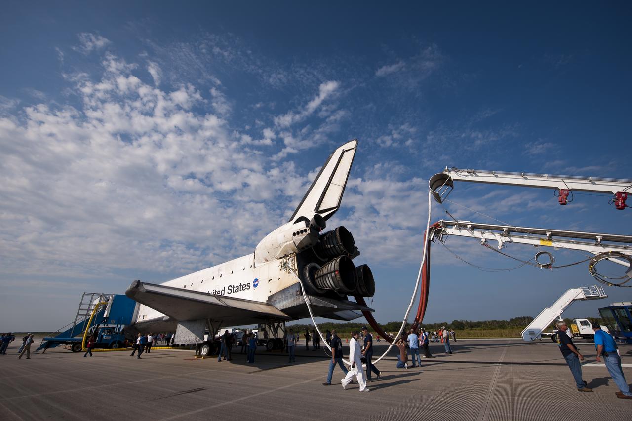 NASA and contractor personnel work on the space shuttle Atlantis at the Kennedy Space Center Shuttle Landing Facility (SLF) shortly after Atlantis (STS-135) landed early Thursday morning, July 21, 2011, in Cape Canaveral, Fla. Overall, Atlantis spent 307 days in space and traveled nearly 126 million miles during its 33 flights. Atlantis, the fourth orbiter built, launched on its first mission on Oct. 3, 1985. Photo Credit: (NASA/Bill Ingalls)