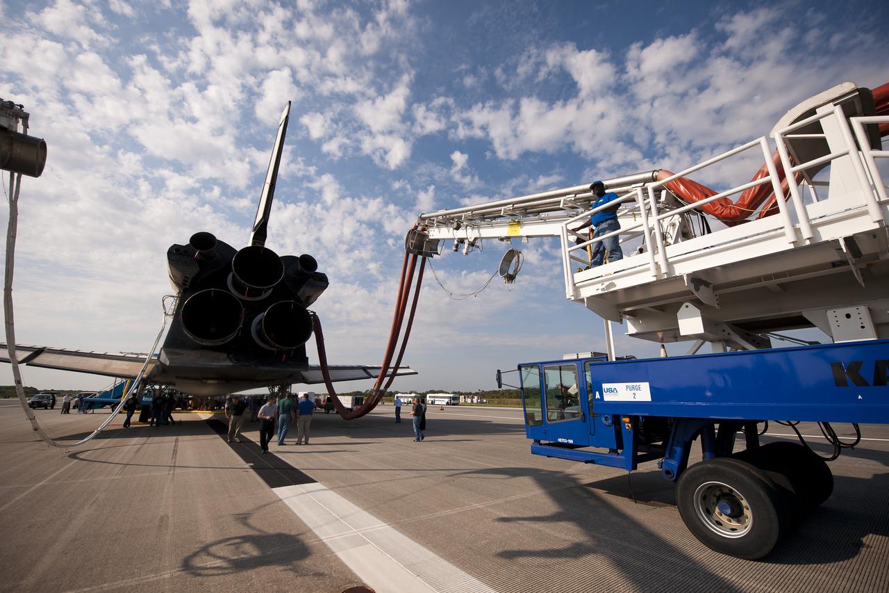 NASA and contractor personnel work on the space shuttle Atlantis at the Kennedy Space Center Shuttle Landing Facility (SLF) shortly after Atlantis (STS-135) landed early Thursday morning, July 21, 2011, in Cape Canaveral, Fla. Overall, Atlantis spent 307 days in space and traveled nearly 126 million miles during its 33 flights. Atlantis, the fourth orbiter built, launched on its first mission on Oct. 3, 1985. Photo Credit: (NASA/Bill Ingalls)