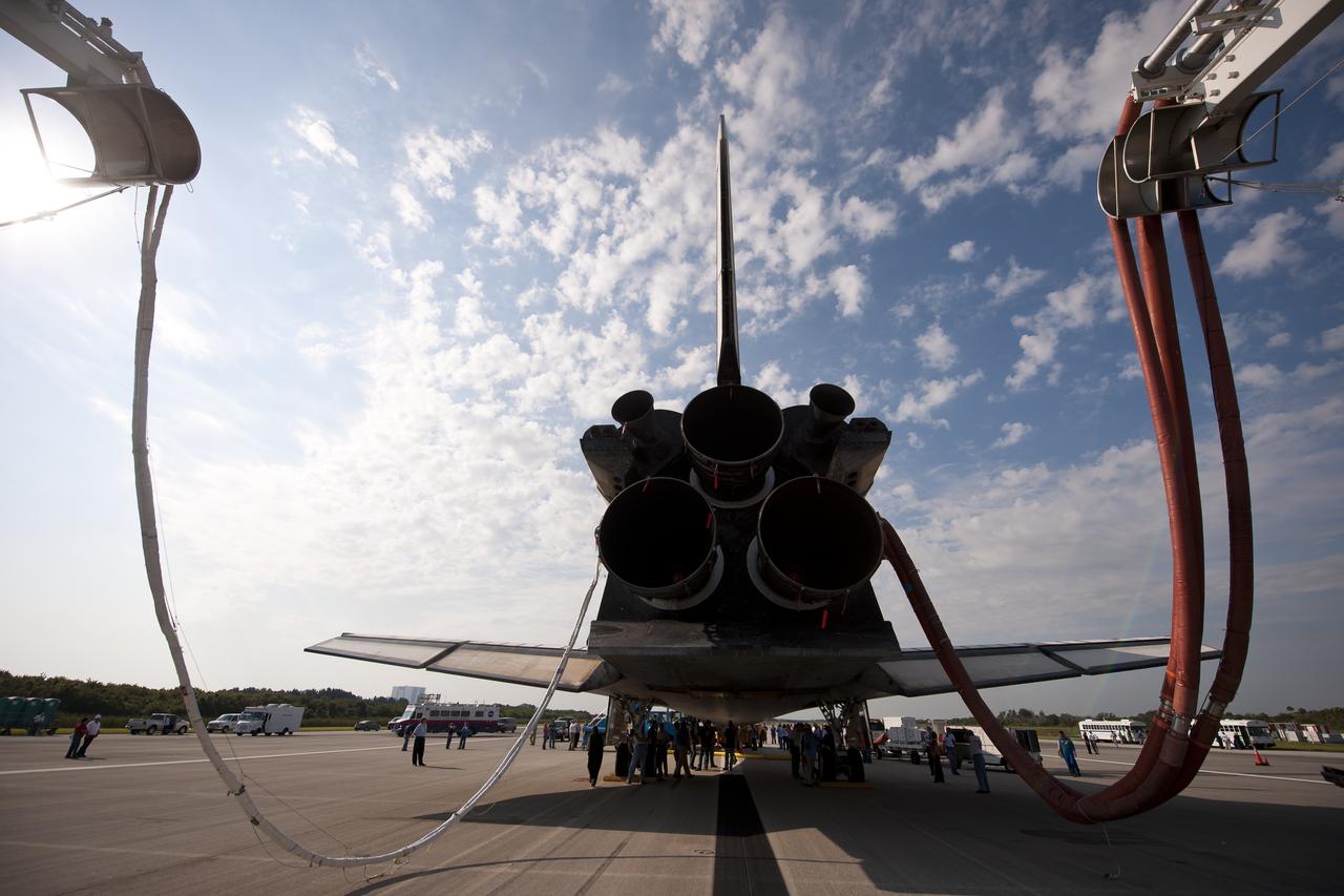 NASA and contractor personnel work on the space shuttle Atlantis at the Kennedy Space Center Shuttle Landing Facility (SLF) shortly after Atlantis (STS-135) landed early Thursday morning, July 21, 2011, in Cape Canaveral, Fla. Overall, Atlantis spent 307 days in space and traveled nearly 126 million miles during its 33 flights. Atlantis, the fourth orbiter built, launched on its first mission on Oct. 3, 1985. Photo Credit: (NASA/Bill Ingalls)