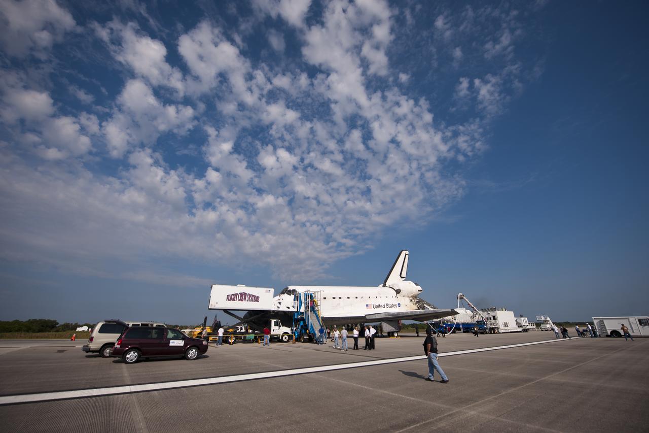 NASA and contractor personnel work on the space shuttle Atlantis at the Kennedy Space Center Shuttle Landing Facility (SLF) shortly after Atlantis (STS-135) landed early Thursday morning, July 21, 2011, in Cape Canaveral, Fla. Overall, Atlantis spent 307 days in space and traveled nearly 126 million miles during its 33 flights. Atlantis, the fourth orbiter built, launched on its first mission on Oct. 3, 1985. Photo Credit: (NASA/Bill Ingalls)
