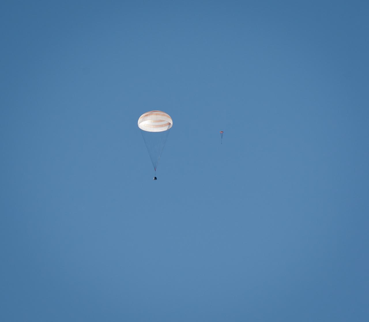 The Soyuz TMA-21 spacecraft and the drogue chute are seen during the landing with Expedition 28 Commander Andrey Borisenko, and Flight Engineers Ron Garan, and Alexander Samokutyaev in a remote area outside of the town of Zhezkazgan, Kazakhstan, on Friday, Sept. 16, 2011. NASA Astronaut Garan, Russian Cosmonauts Borisenko and Samokutyaev are returning from more than five months onboard the International Space Station where they served as members of the Expedition 27 and 28 crews. Photo Credit: (NASA/Bill Ingalls)
