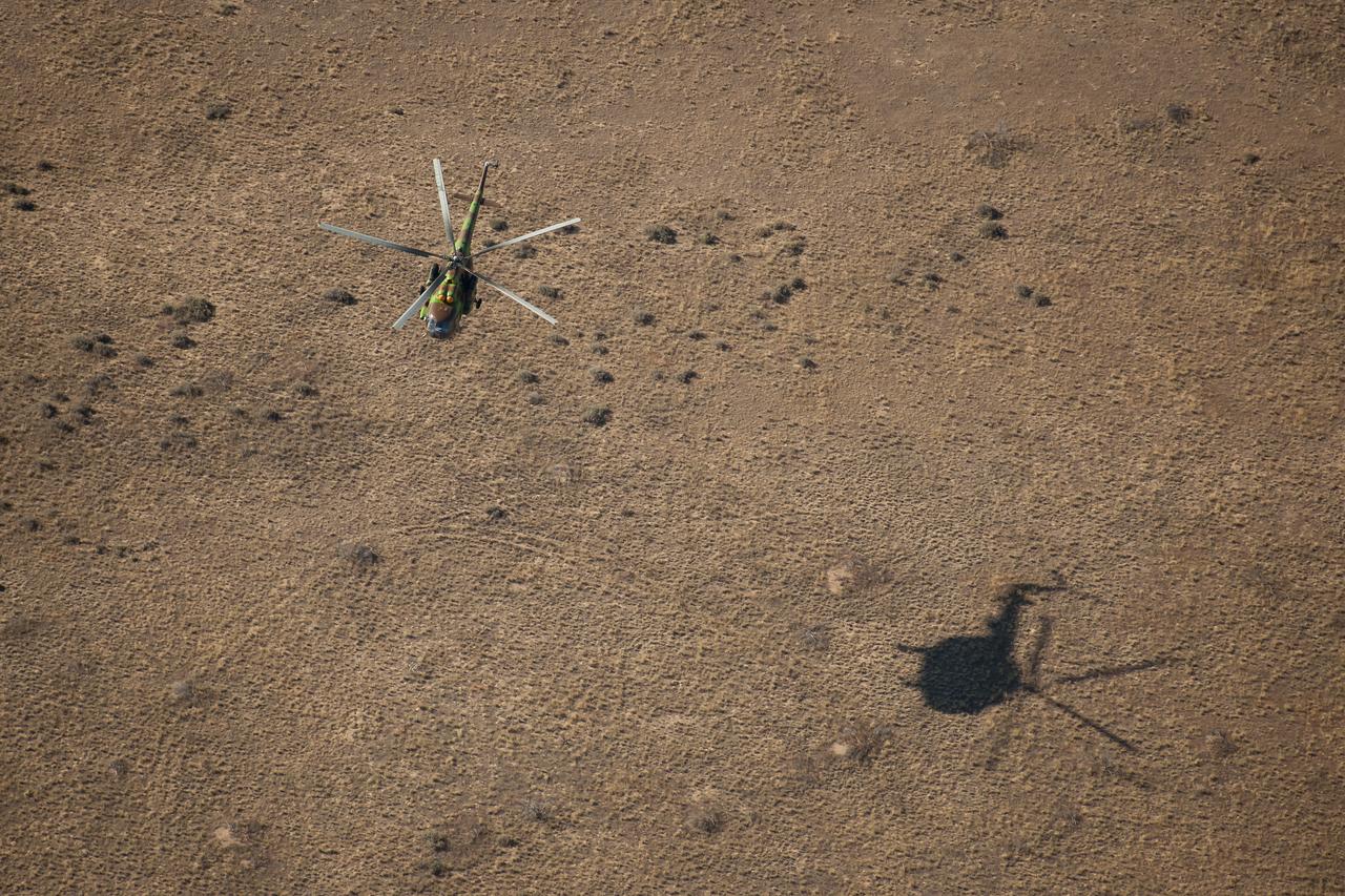 A Russian Search and Rescue helicopter approaches the landing site of the Soyuz TMA-21 spacecraft shortly after it landed with Expedition 28 Commander Andrey Borisenko, and Flight Engineers Ron Garan, and Alexander Samokutyaev in a remote area outside of the town of Zhezkazgan, Kazakhstan, on Friday, Sept. 16, 2011. NASA Astronaut Garan, Russian Cosmonauts Borisenko and Samokutyaev are returning from more than five months onboard the International Space Station where they served as members of the Expedition 27 and 28 crews. Photo Credit: (NASA/Bill Ingalls)