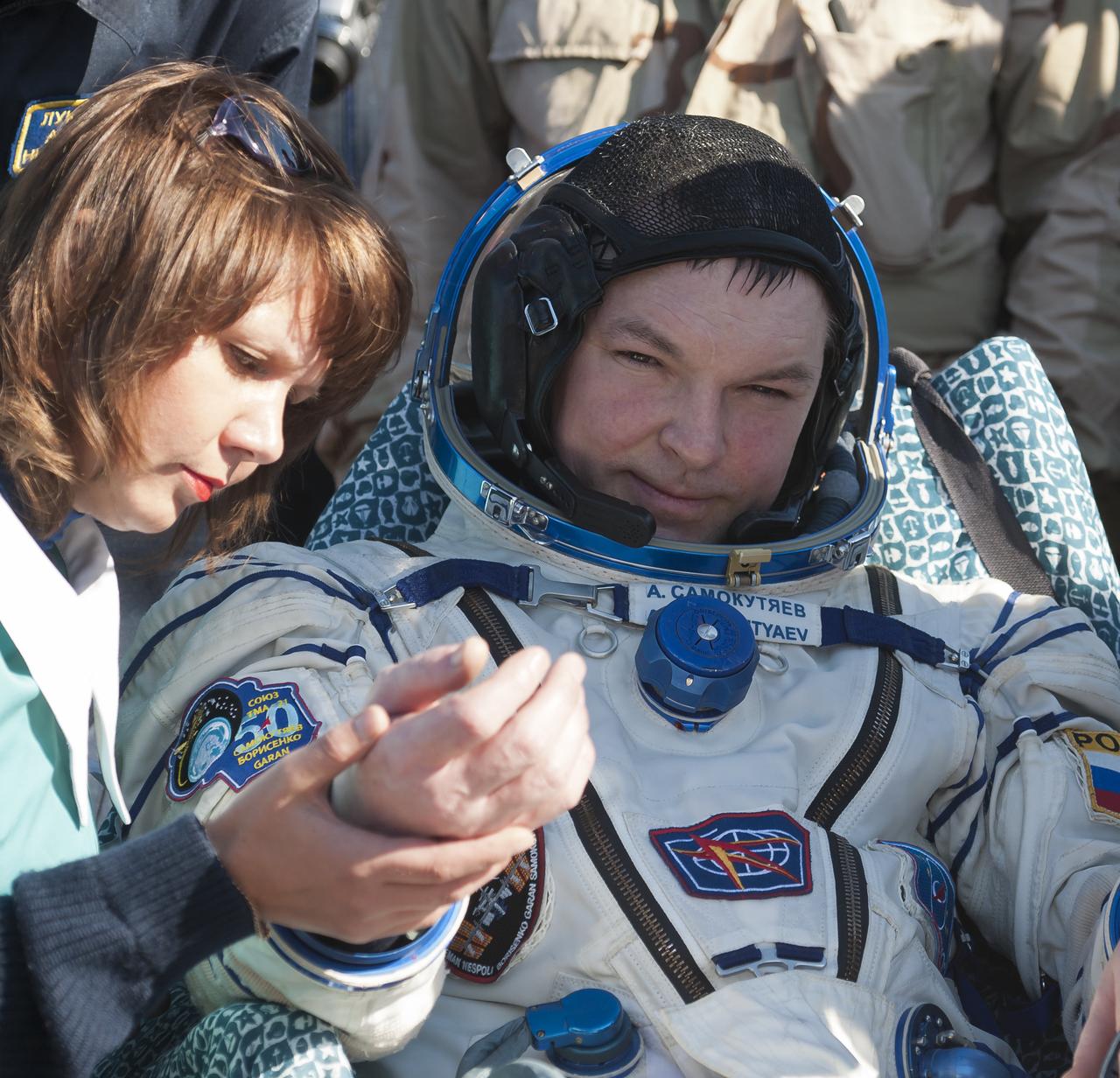 Expedition 28 Flight Engineer Alexander Samokutyaev is given a routine medical check outside the Soyuz TMA-21 Capsule just minutes after he and Expedition 28 Commander Andrey Borisenko, and Flight Engineer Ron Garan landed in a remote area outside the town of Zhezkazgan, Kazakhstan, on Friday, Sept. 16, 2011. NASA Astronaut Garan, Russian Cosmonauts Borisenko and Samokutyaev are returning from more than five months onboard the International Space Station where they served as members of the Expedition 27 and 28 crews. Photo Credit: (NASA/Bill Ingalls)