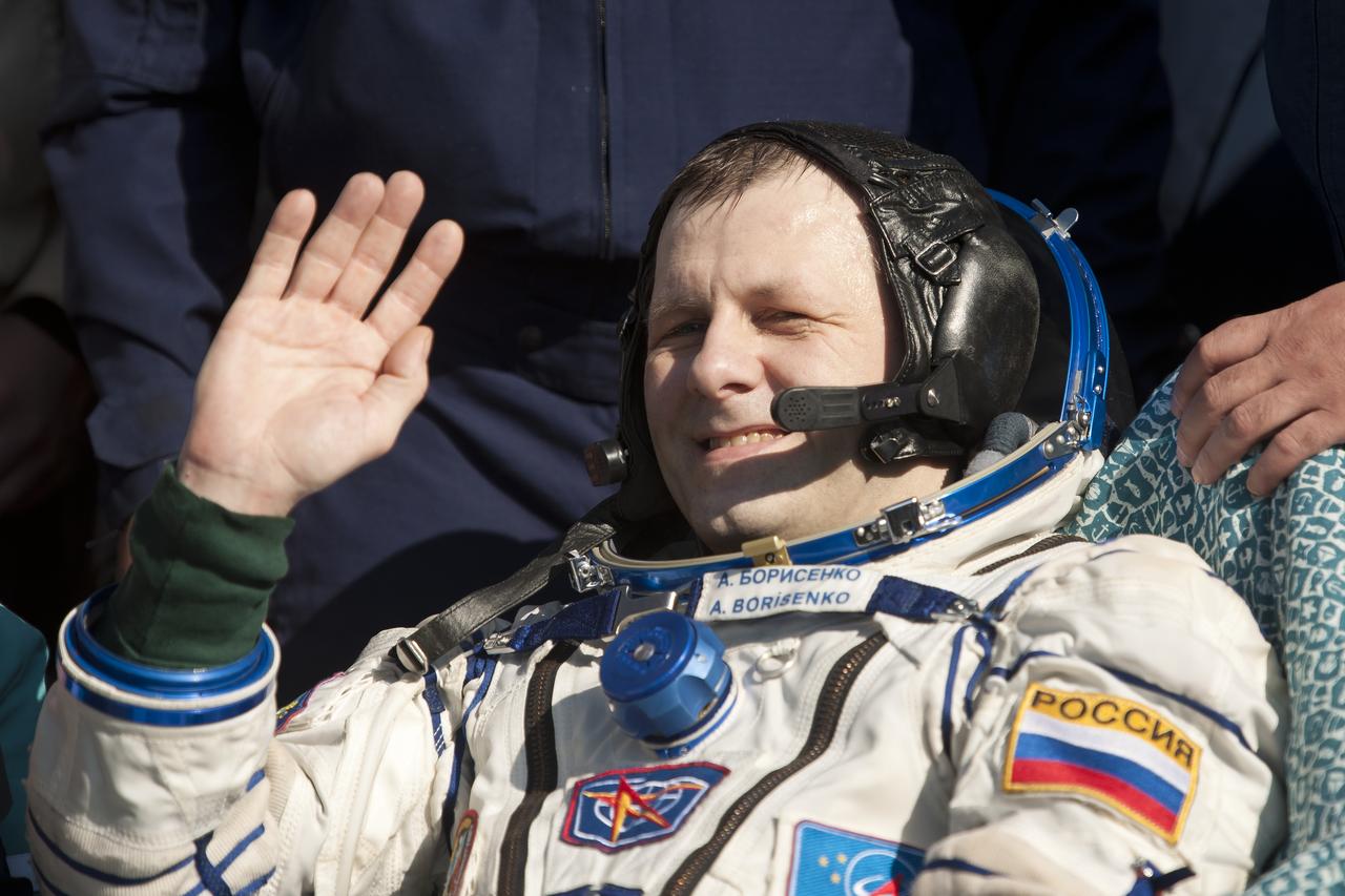 Expedition 28 Commander Andrey Borisenko waves hello to the TV cameras outside the Soyuz TMA-21 Capsule just minutes after he and Expedition 28 Flight Engineers Alexander Samokutyaev, and Ron Garan landed in a remote area outside the town of Zhezkazgan, Kazakhstan, on Friday, Sept. 16, 2011. NASA Astronaut Garan, Russian Cosmonauts Borisenko and Samokutyaev are returning from more than five months onboard the International Space Station where they served as members of the Expedition 27 and 28 crews. Photo Credit: (NASA/Bill Ingalls)