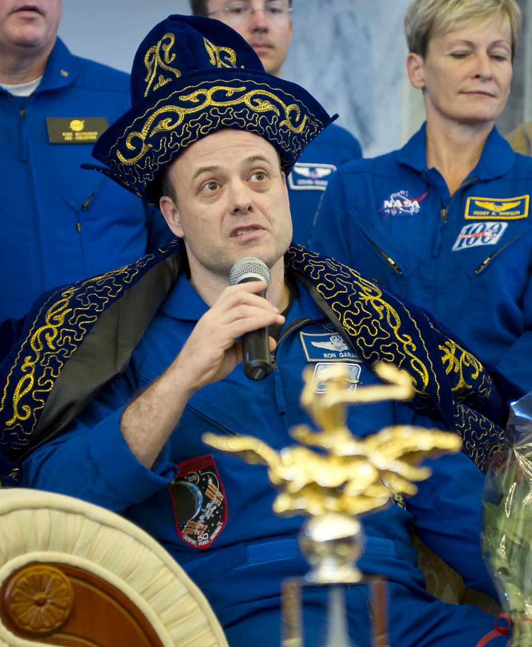 Expedition 28 Flight Engineer Ron Garan answers reporters questions in traditional Kazakh dress during a press conference at the Karaganda airport shortly after he and Expedition 28 Commander Andrey Borisenko and Flight Engineer Ron Garan landed in their Soyuz TMA-21 outside of the town of Zhezkazgan, Kazakhstan, on Friday, Sept. 16, 2011. Garan, Borisenko and Samokutyaev are returning from more than five months onboard the International Space Station where they served as members of the Expedition 27 and 28 crews. Photo Credit: (NASA/Bill Ingalls)