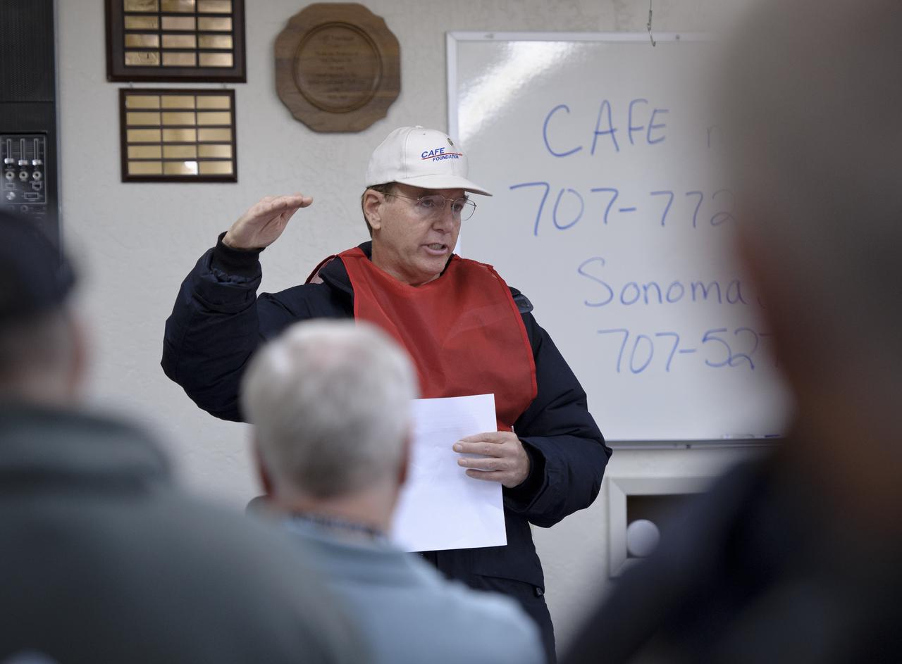 Brien A. Seeley M.D., President of Comparative Aircraft Flight Efficiency (CAFE) Foundation briefs pilots and ground crew prior to competition as part of the 2011 Green Flight Challenge, sponsored by Google, at the Charles M. Schulz Sonoma County Airport in Santa Rosa, Calif. on Monday, Sept. 26, 2011.  NASA and the Comparative Aircraft Flight Efficiency (CAFE) Foundation are having the challenge with the goal to advance technologies in fuel efficiency and reduced emissions with cleaner renewable fuels and electric aircraft. Photo Credit: (NASA/Bill Ingalls)