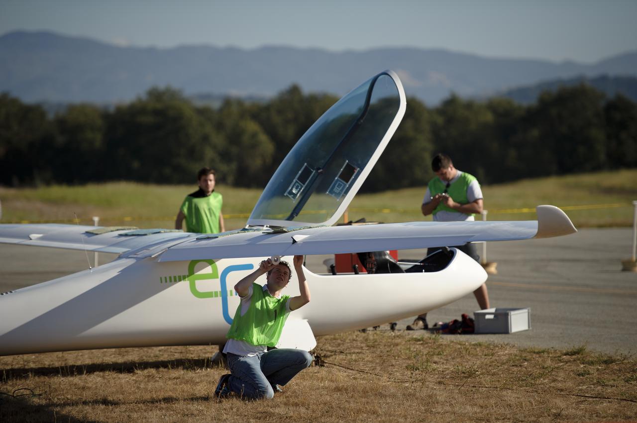 Team members of the e-Genius aircraft prepare their plane prior to competition as part of the 2011 Green Flight Challenge, sponsored by Google, at the Charles M. Schulz Sonoma County Airport in Santa Rosa, Calif. on Monday, Sept. 26, 2011.  NASA and the Comparative Aircraft Flight Efficiency (CAFE) Foundation are having the challenge with the goal to advance technologies in fuel efficiency and reduced emissions with cleaner renewable fuels and electric aircraft. Photo Credit: (NASA/Bill Ingalls)
