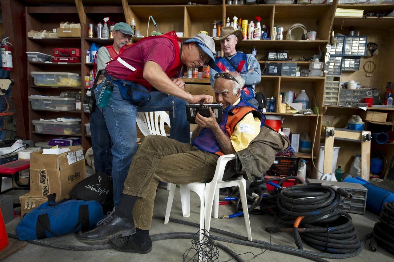Sid Siddiqi, seated, and other support personnel prepare noise level measuring equipment for the 2011 Green Flight Challenge, sponsored by Google, at the Charles M. Schulz Sonoma County Airport in Santa Rosa, Calif. on Monday, Sept. 26, 2011.  NASA and the Comparative Aircraft Flight Efficiency (CAFE) Foundation are having the challenge with the goal to advance technologies in fuel efficiency and reduced emissions with cleaner renewable fuels and electric aircraft. Photo Credit: (NASA/Bill Ingalls)