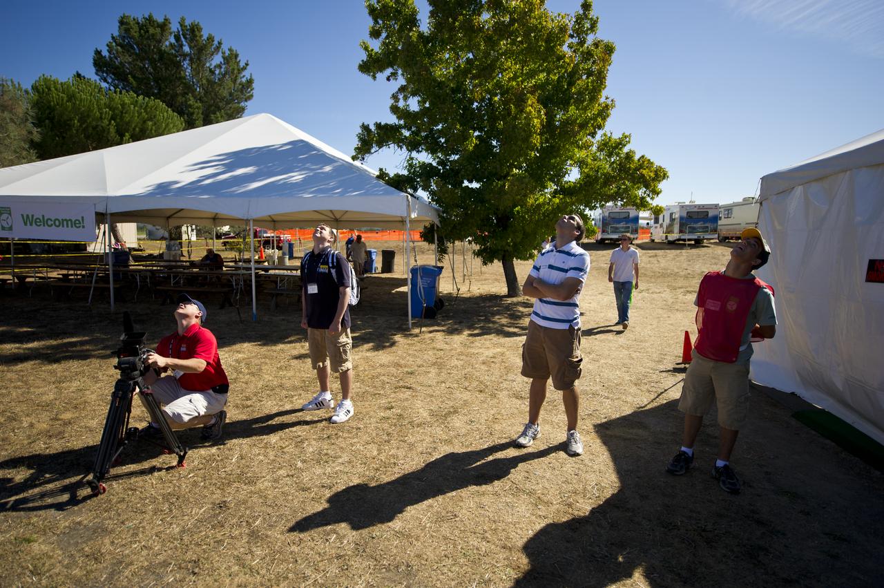 Media and ground crew look at aircraft as they participate in the miles per gallon (MPG) flight during the 2011 Green Flight Challenge, sponsored by Google, at the Charles M. Schulz Sonoma County Airport in Santa Rosa, Calif. on Tuesday, Sept. 27, 2011.  NASA and the Comparative Aircraft Flight Efficiency (CAFE) Foundation are having the challenge with the goal to advance technologies in fuel efficiency and reduced emissions with cleaner renewable fuels and electric aircraft. Photo Credit: (NASA/Bill Ingalls)