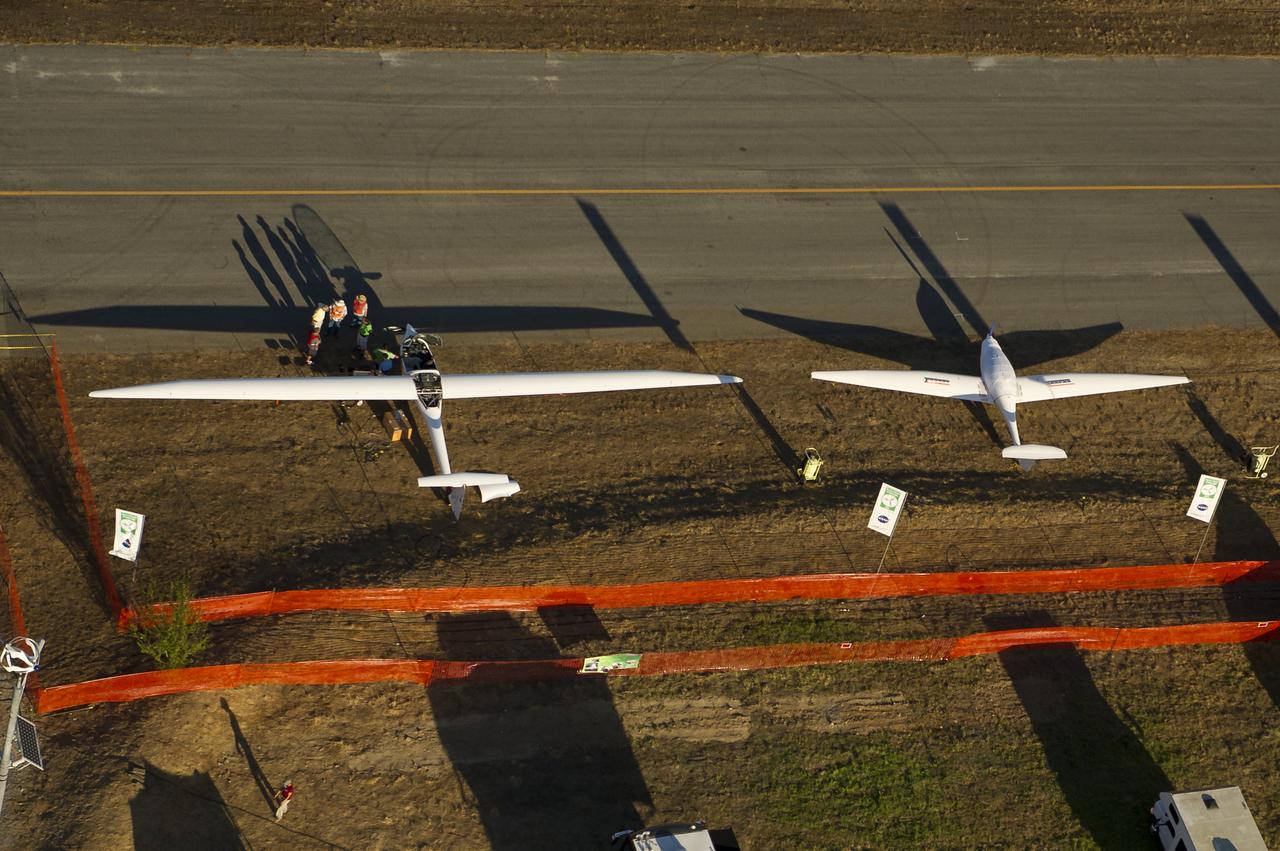The EcoEagle, left, and the PhoEnix aircraft are seen on the campus of the 2011 Green Flight Challenge, sponsored by Google, at the Charles M. Schulz Sonoma County Airport in Santa Rosa, Calif. on Wednesday, Sept. 28, 2011. NASA and the Comparative Aircraft Flight Efficiency (CAFE) Foundation are having the challenge with the goal to advance technologies in fuel efficiency and reduced emissions with cleaner renewable fuels and electric aircraft. Photo Credit: (NASA/Bill Ingalls)