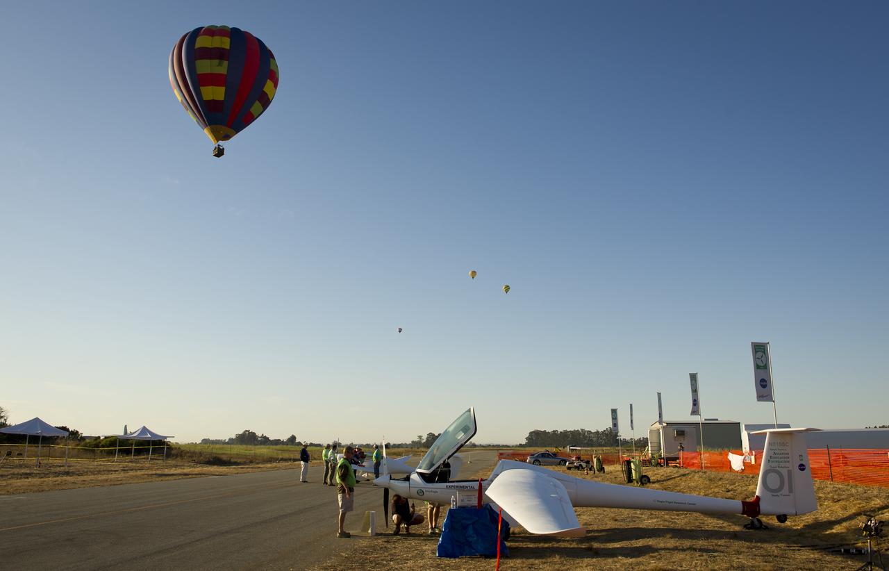 A hot air balloons pass over the campus of the 2011 Green Flight Challenge, sponsored by Google, at the Charles M. Schulz Sonoma County Airport in Santa Rosa, Calif. on Thursday, Sept. 29, 2011. NASA and the Comparative Aircraft Flight Efficiency (CAFE) Foundation are having the challenge with the goal to advance technologies in fuel efficiency and reduced emissions with cleaner renewable fuels and electric aircraft. Photo Credit: (NASA/Bill Ingalls)