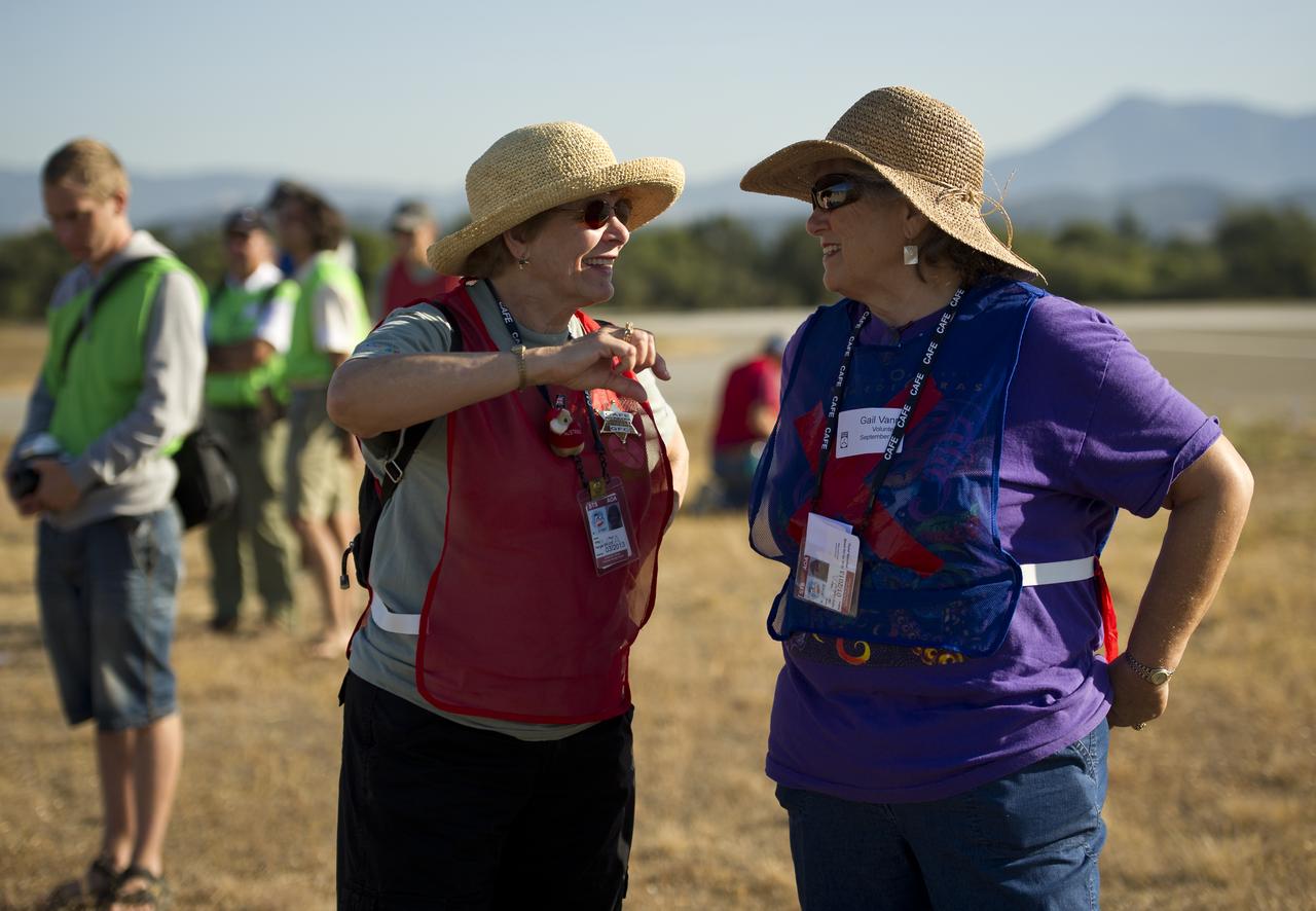 CAFE Foundation safety volunteers Meg Hurt, left, and Gail Vann wait on the runway for the arrival of the next aircraft to take part in the speed competition during the 2011 Green Flight Challenge, sponsored by Google, at the Charles M. Schulz Sonoma County Airport in Santa Rosa, Calif. on Thursday, Sept. 29, 2011. NASA and the Comparative Aircraft Flight Efficiency (CAFE) Foundation are having the challenge with the goal to advance technologies in fuel efficiency and reduced emissions with cleaner renewable fuels and electric aircraft. Photo Credit: (NASA/Bill Ingalls)
