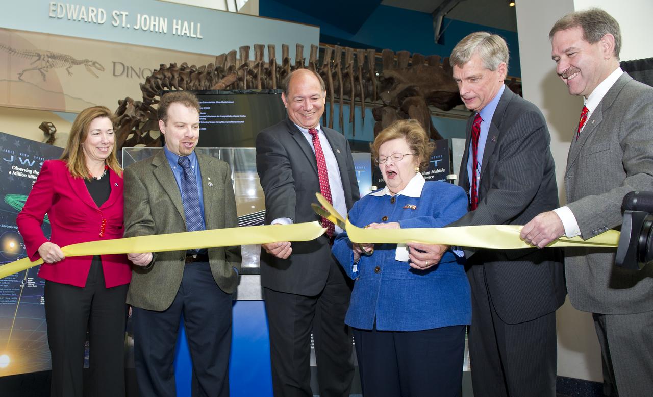 U.S. Senator Barbara Mikulski (D-Md.), third from right, cuts the yellow ribbon presenting the James Webb Space Telescope permanent exhibit at the Maryland Science Center on Wednesday, Oct. 26, 2011 in Baltimore.  Mikulski is joined by NASA Deputy Administrator Lori Garver, far left; Adam Reiss, recipient of the 2011 Nobel Prize in Physics and professor of astronomy and physics at Johns Hopkins University; Jeffrey Grant, VP and General Manager of the Space Systems Division, Northrop Grumman; Van Reiner, President and CEO of the Maryland Science Center, Baltimore and Dr. John Grunsfeld, former astronaut and Deputy Director, Space Telescope Science Institute (STScI), Baltimore.  The Webb telescope will provide images of the first galaxies ever formed and explore planets around distant stars.  Photo Credit:  (NASA/Carla Cioffi)