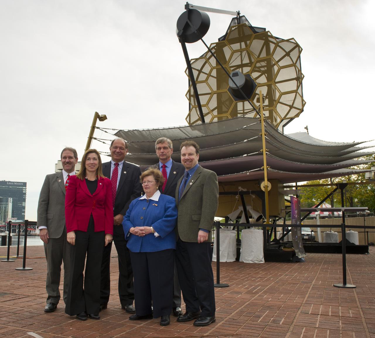 NASA, space science industry and government officials are seen in front of a full-size model of NASA's James Webb Space Telescope at the Maryland Science Center in Baltimore, Wednesday, Oct. 26, 2011.  From left, back row are:  Dr. John Grunsfeld, former astronaut and Deputy Director, Space Telescope Science Institute (STScI), Baltimore; Jeffrey Grant, VP and General Manager of the Space Systems Division, Northrop Grumman; Van Reiner, President and CEO of the Maryland Science Center, Baltimore and Adam Reiss, recipient of the 2011 Nobel Prize in Physics and professor of astronomy and physics at Johns Hopkins University.  In the front row are NASA Deputy Administrator Lori Garver, left, and U.S. Senator Barbara Mikulski (D-Md.).  Photo Credit:  (NASA/Carla Cioffi)