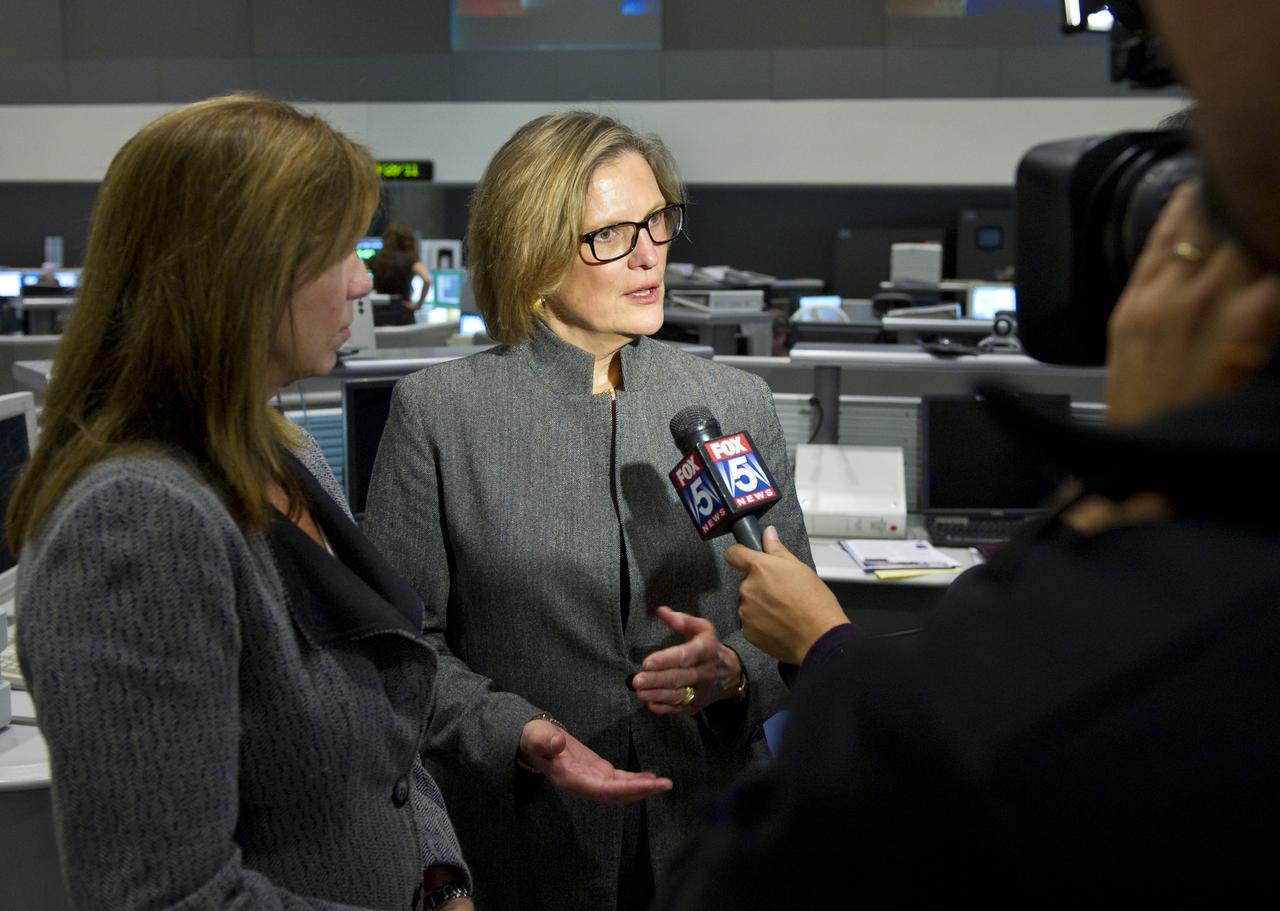 Dr. Kathy Sullivan, center, Deputy Administrator of the National Oceanic and Atmospheric Administration (NOAA) and former NASA astronaut is interviewed by a local television network at NOAA's Satellite Operations Facility in Suitland, Md. after the successful launch of the National Polar-orbiting Operational Environmental Satellite System Preparatory Project (NPP) on Friday, Oct. 28, 2011.  NPP is a joint venture between NASA and NOAA, and is the nation's newest Earth-observing satellite, which will provide data on climate change science, allow for accurate weather forecasts and advance warning for severe weather.  NPP was launched from Vandenberg Air Force Base in California.  Photo Credit:  (NASA/Carla Cioffi)