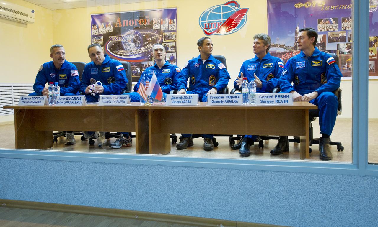 Expedition 29 crew members NASA Flight Engineer Daniel Burbank, far left, Russian Soyuz Commander Anton Shkaplerov, Russian Flight Engineer Anatoly Ivanishin, Expedition 29 NASA back up crew member  Joseph Acaba, backup Soyuz Commander Gennady Padalka and backup Flight Engineer Sergei Revin are seen at the start of a press conference held at the Cosmonaut Hotel in Baikonur, Kazakhstan on Saturday, Nov. 12, 2011.  Photo Credit: (NASA/Carla Cioffi)