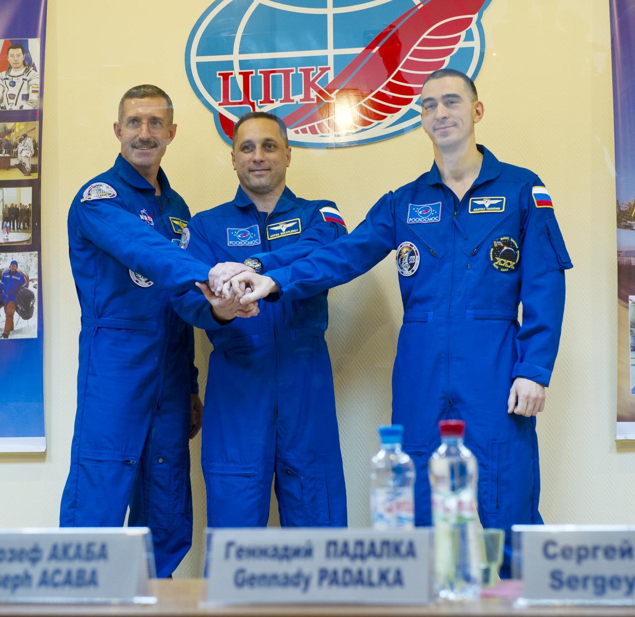 Expedition 29 crew members NASA Flight Engineer Daniel Burbank, far left, Russian Soyuz Commander Anton Shkaplerov, center, and Russian Flight Engineer Anatoly Ivanishin pose for photos at the end of a press conference held at the Cosmonaut Hotel in Baikonur, Kazakhstan on Saturday, Nov. 12, 2011.  Photo Credit: (NASA/Carla Cioffi)