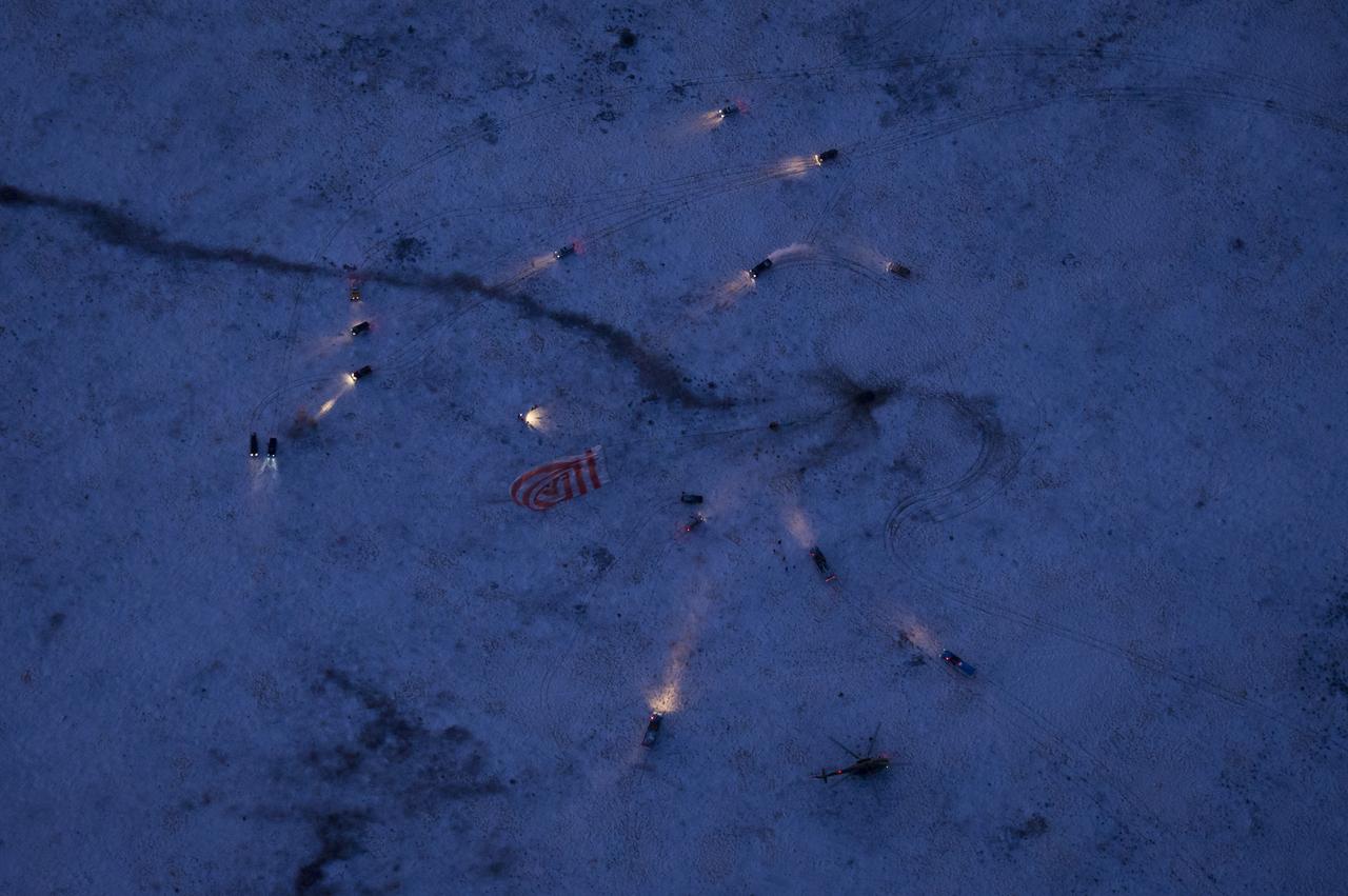 Russian support personnel arrive to help meet the Soyuz TMA-02M spacecraft shortly after the capsule landed with Expedition 29 Commander Mike Fossum, and Flight Engineers Sergei Volkov and Satoshi Furukawa in a remote area outside of the town of Arkalyk, Kazakhstan, on Tuesday, Nov. 22, 2011. NASA Astronaut Fossum, Russian Cosmonaut Volkov and JAXA (Japan Aerospace Exploration Agency) Astronaut Furukawa are returning from more than five months onboard the International Space Station where they served as members of the Expedition 28 and 29 crews. Photo Credit: (NASA/Bill Ingalls)