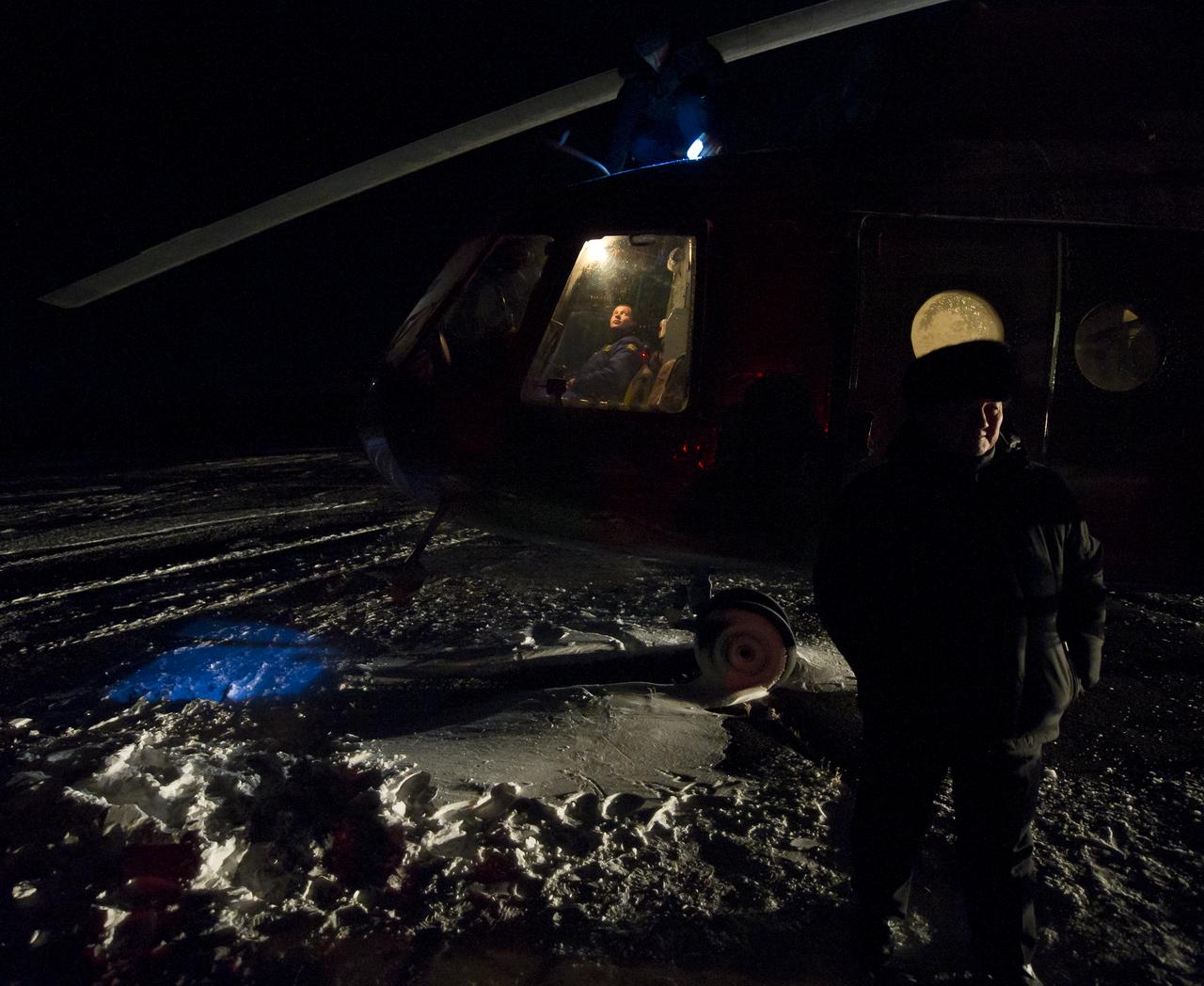 The Mayor of Arkalyk, right, waits to board a Russian Search and Rescue helicopter for take off in support of the Soyuz TMA-02M spacecraft landing with Expedition 29 Commander Mike Fossum, and Flight Engineers Sergei Volkov and Satoshi Furukawa in Arkalyk, Kazakhstan, on Tuesday, Nov. 22, 2011. NASA Astronaut Fossum, Russian Cosmonaut Volkov and JAXA (Japan Aerospace Exploration Agency) Astronaut Furukawa are returning from more than five months onboard the International Space Station where they served as members of the Expedition 28 and 29 crews. Photo Credit: (NASA/Bill Ingalls)