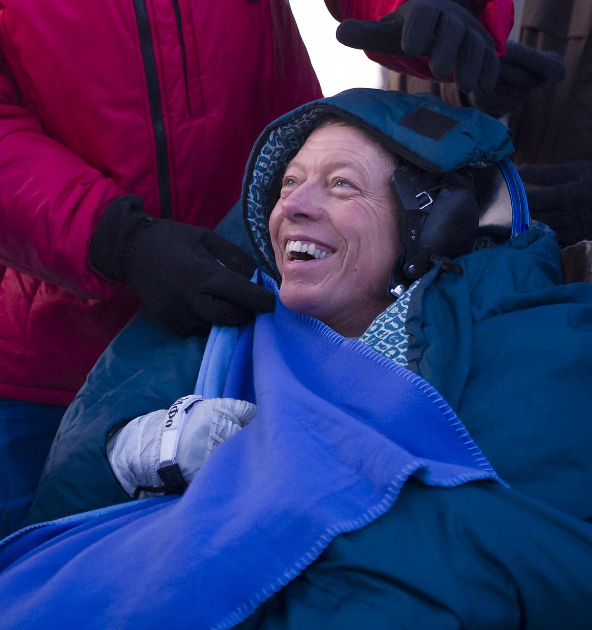 Expedition 29 Commander Mike Fossum smiles as he rest outside the Soyuz TMA-02M Capsule just minutes after he and Expedition 29 Flight Engineers Sergei Volkov and Satoshi Furukawa landed in a remote area outside of the town of Arkalyk, Kazakhstan, on Tuesday, Nov. 22, 2011. NASA Astronaut Fossum, Russian Cosmonaut Volkov and JAXA (Japan Aerospace Exploration Agency) Astronaut Furukawa are returning from more than five months onboard the International Space Station where they served as members of the Expedition 28 and 29 crews. Photo Credit: (NASA/Bill Ingalls)