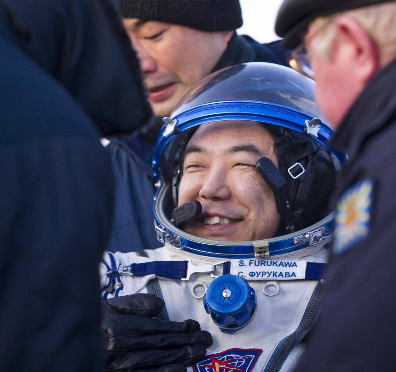 Expedition 29 Flight Engineer, JAXA (Japan Aerospace Exploration Agency) Astronaut, Satoshi Furukawa smiles as he is helped to a chair outside the Soyuz TMA-02M Capsule just minutes after he and Expedition 29 Commander Mike Fossum and Flight Engineer Sergei Volkov landed in a remote area outside of the town of Arkalyk, Kazakhstan, on Tuesday, Nov. 22, 2011. NASA Astronaut Fossum, Russian Cosmonaut Volkov and JAXA (Japan Aerospace Exploration Agency) Astronaut Furukawa are returning from more than five months onboard the International Space Station where they served as members of the Expedition 28 and 29 crews. Photo Credit: (NASA/Bill Ingalls)