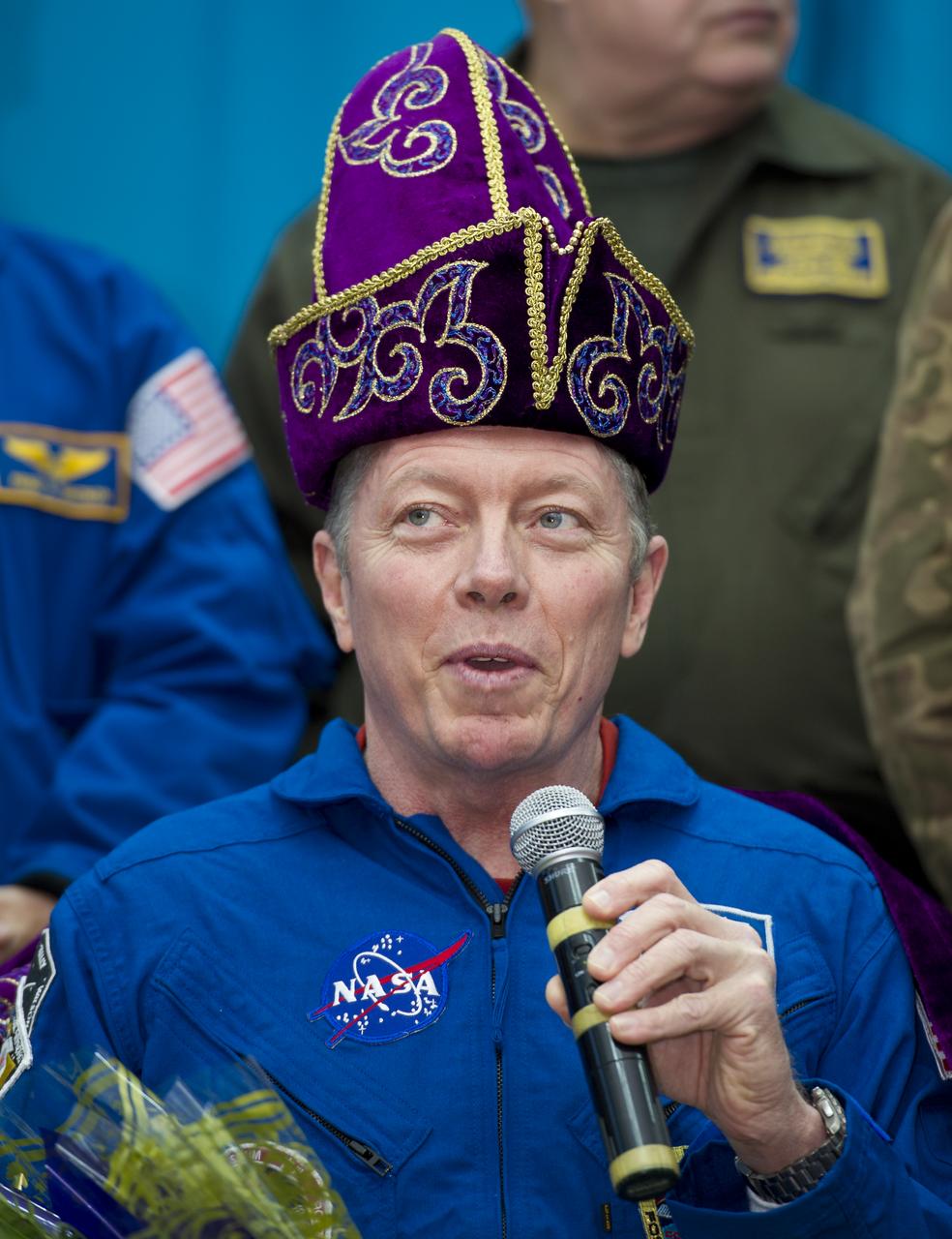 Expedition 29 Commander Mike Fossum is seen in a traditional Kazakhstan hat gifted to him during a welcome ceremony at the Kustanay Airport in Kazakhstan on Tuesday, Nov. 22, 2011. NASA Astronaut Fossum, Russian Cosmonaut Sergei Volkov and JAXA (Japan Aerospace Exploration Agency) Astronaut Satoshi Furukawa returned from more than five months onboard the International Space Station where they served as members of the Expedition 28 and 29 crews. Photo Credit: (NASA/Bill Ingalls)