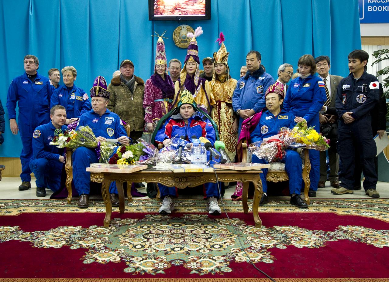 Seated from left, Expedition 29 Commander Mike Fossum, Flight Engineers Sergei Volkov, and Satoshi Furukawa are seen during a welcome ceremony and press conference at the Kustanay Airport in Kazakhstan on Tuesday, Nov. 22, 2011. NASA Astronaut Fossum, Russian Cosmonaut Volkov and JAXA (Japan Aerospace Exploration Agency) Astronaut Furukawa returned from more than five months onboard the International Space Station where they served as members of the Expedition 28 and 29 crews. Photo Credit: (NASA/Bill Ingalls)