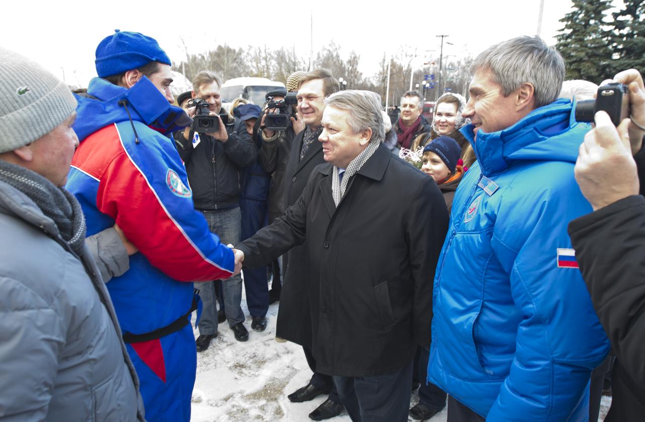 Expedition 29 Flight Engineer Sergei Volkov shakes hands with Federal Space Agency head Vladimir Popovkin as he is welcomed home in Star City, Russia on Tuesday, Nov. 22, 2011.  Russian Cosmonaut Volkov, Expedition 29 Commander Mike Fossum, and JAXA (Japan Aerospace Exploration Agency) Flight Engineer Satoshi Furukawa returned  to Arkalyk, Kazakhstan earlier in the day from over five months onboard the International Space Station where they served as members of the Expedtion 28 and 29 crews. Photo Credit: (NASA/Bill Ingalls)