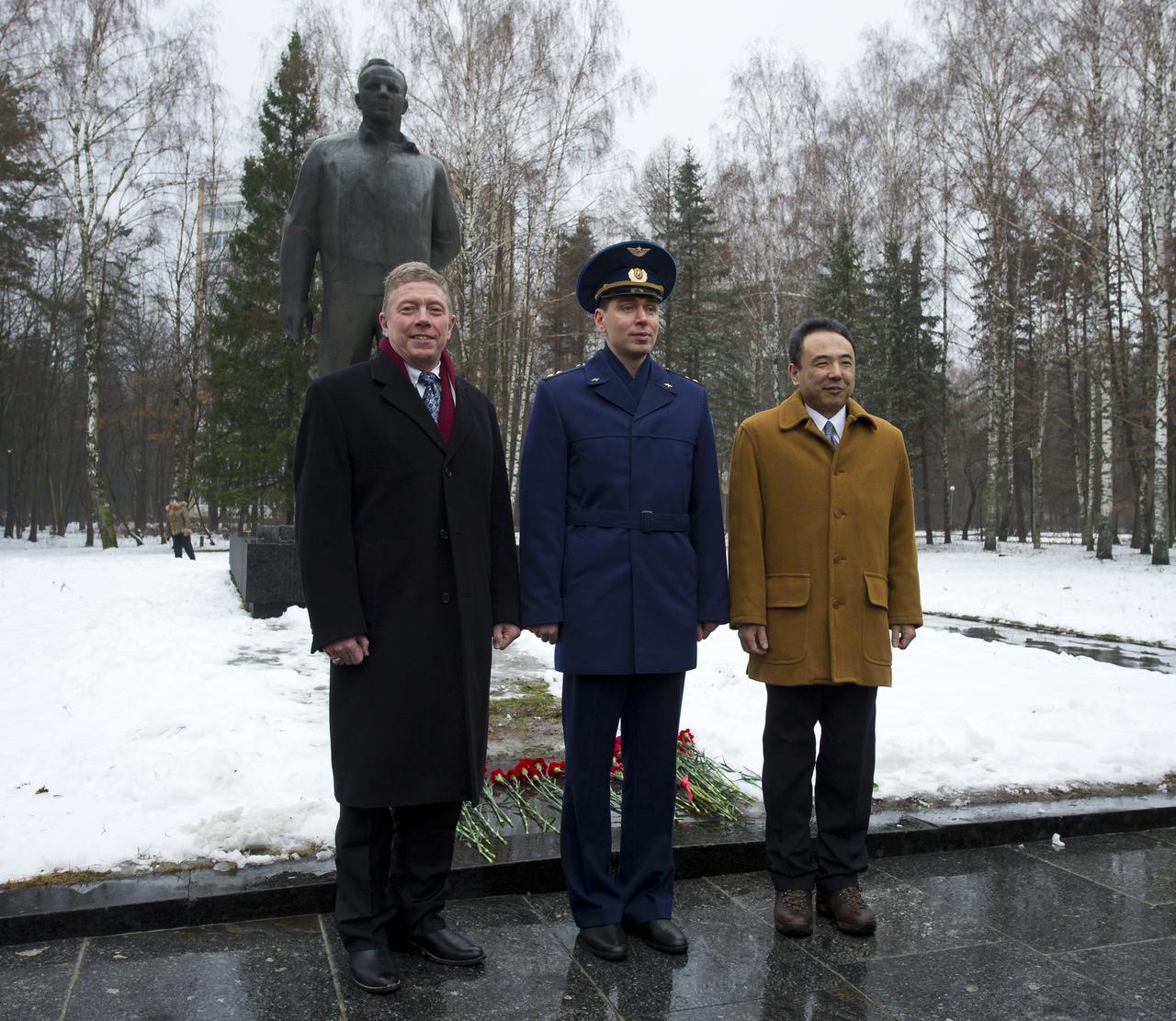 Expedition 29 Commander Mike Fossum, left, Russian cosmonaut Sergei Volkov and Japanese Aerospace Exploration Agency astronaut Satoshi Furukawa, right, are seen in front of a statue of Yuri Gagarin at the Gagarin Cosmonaut Training Center in Star City, Russia as part of a traditional welcome home ceremony on Thursday, Dec. 15, 2011.  The crew landed on the steppes of Kazakhstan on November 22nd after spending five months living and working aboard the International Space Station.  Photo Credit:  (NASA/Carla Cioffi)