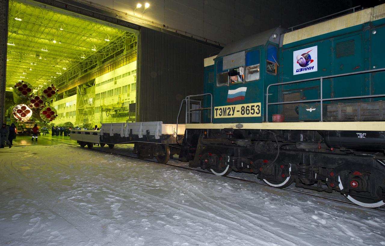 A locomotive backs into Building 112 as it prepares to hitch up with the railcar that will transport the Soyuz TMA-03M to the launch pad at the Baikonur Cosmodrome in Kazakhstan, Monday, Dec. 19, 2011.  The launch of the Soyuz spacecraft with Expedition 30 Soyuz Commander Oleg Kononenko of Russia, NASA Flight Engineer Don Pettit and ESA (European Space Agency) astronaut and Flight Engineer Andre Kuipers is scheduled for 7:16 p.m. local time on Wednesday, December 21.  Photo Credit (NASA/Carla Cioffi)