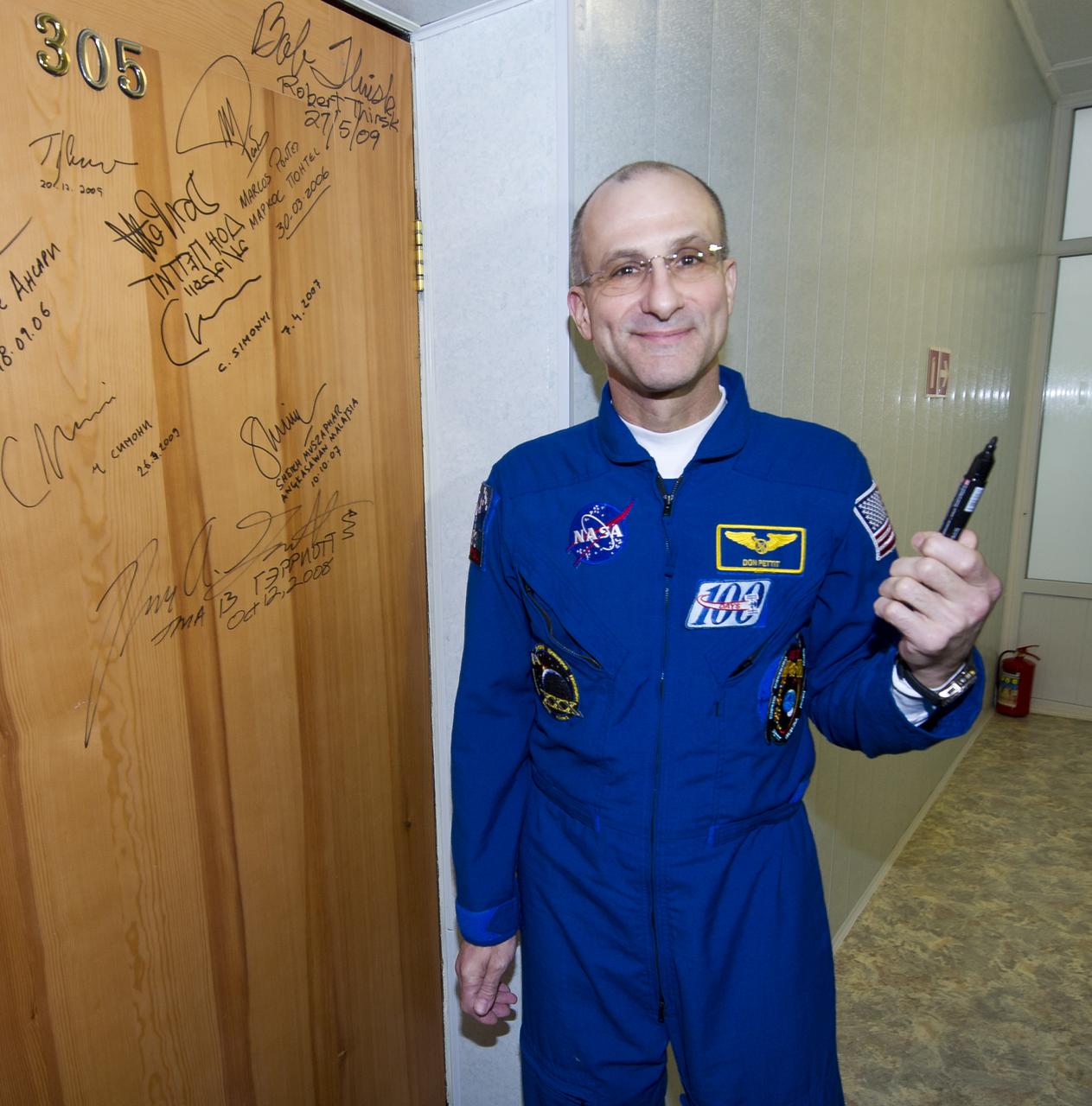 Expedition 30 NASA astronaut and Flight Engineer Don Pettit performs the traditional door signing Wednesday, Dec. 21, 2011 at the Cosmonaut Hotel in Baikonur, Kazakhstan. Pettit was launched onboard the Soyuz rocket the same evening with Expedition 30 Soyuz Commander Oleg Kononenko and ESA (European Space Agency) astronaut Andre Kuiperson a mission to the International Space Station (ISS). Photo Credit: (NASA/Carla Cioffi)