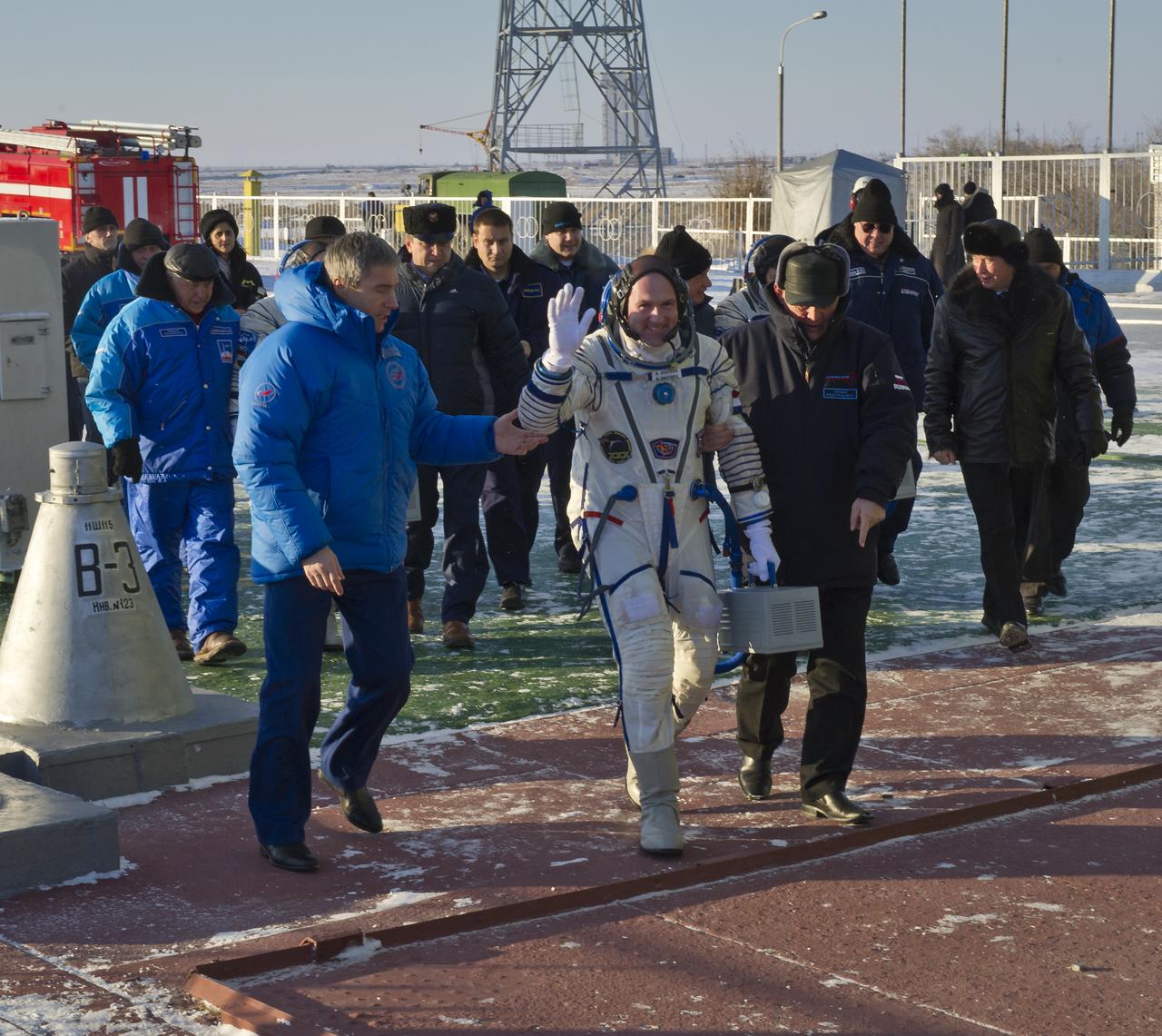 Expedition 30 ESA (European Space Agency) astronaut Andre Kuipers, center, is seen as he is escorted to the Soyuz launch pad just hours prior to his launch aboard the Soyuz TMA-03M spacecraft to the International Space Station at the Baikonur Cosmodrome in Kazakhstan, Wednesday, Dec. 21 2011. Photo Credit: (NASA/Carla Cioffi)