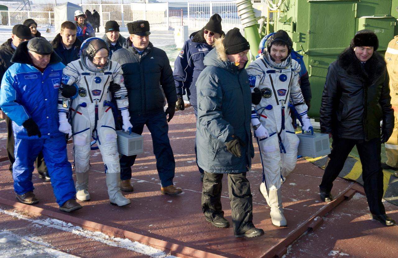 Expedition 30 NASA Flight Engineer Don Pettit, second from left, and Russian cosmonaut and Soyuz Commander Oleg Kononenko, second from right, are seen as they are escorted to the Soyuz launch pad just hours prior to their launch aboard the Soyuz TMA-03M spacecraft to the International Space Station at the Baikonur Cosmodrome in Kazakhstan, Wednesday, Dec. 21 2011.  Photo Credit: (NASA/Carla Cioffi)