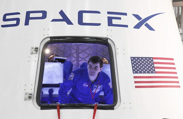 NASA image:  NASA astronaut Rex Walheim checks out the Dragon spacecraft und